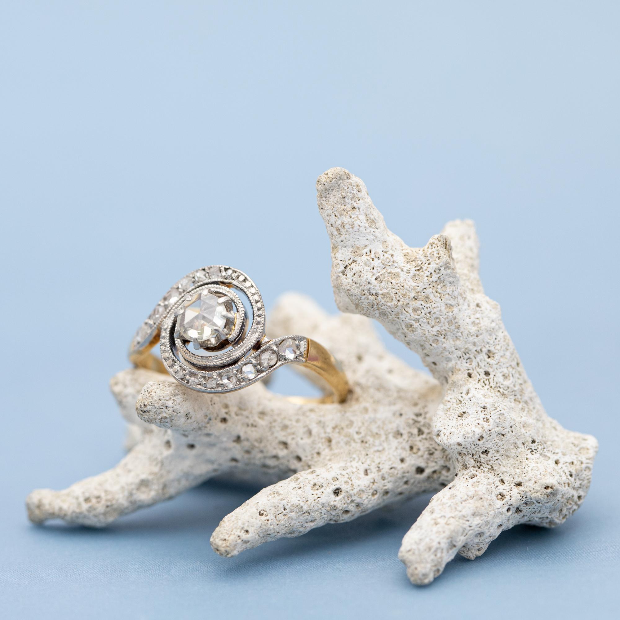 We are delighted to present to you this absolute beauty crafted in 18 karat solid gold. This elegant antique ring has a tourbullion shaped ringhead with a stunning rose cut diamond in its centre. It has a diameter of approximately 4 mm and is of