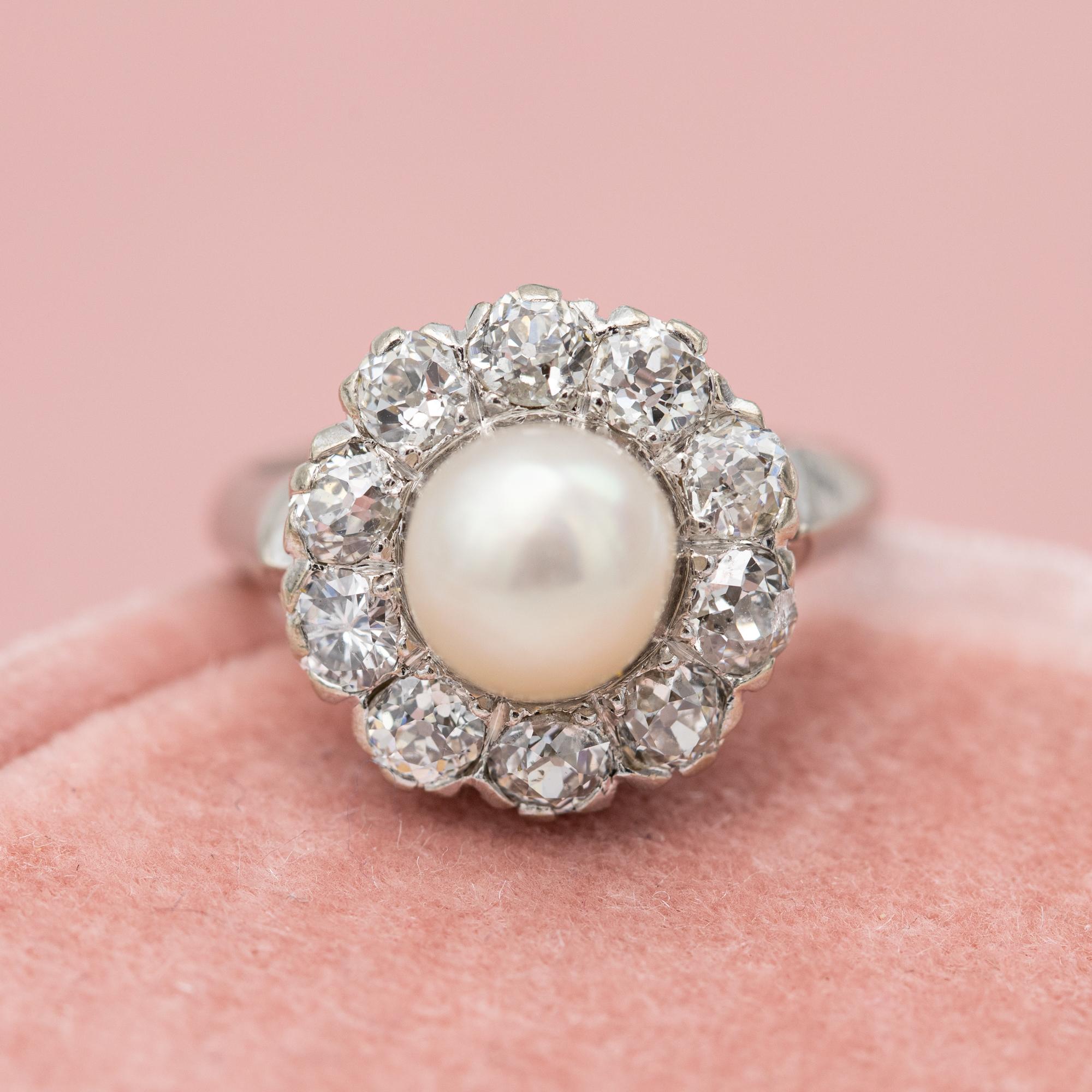 For sale is this incredible pearl and diamond ring. This marvellous ring is made in 18 karat white gold and hallmarked with a makers mark and a 0,750 mark. In the centre we have a lovely romantic white pearl encircled by ten natural diamonds. Nine