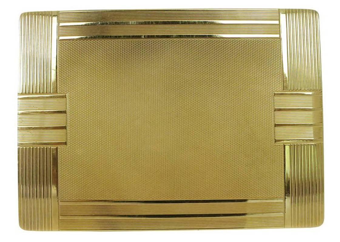 A solid 18-karat gold case with geometric Art Deco lines, this cigarette case has lines textured along the exterior and is completed with a complex grid pattern in the center. It has a hidden latch to open

It also comes with its original slip