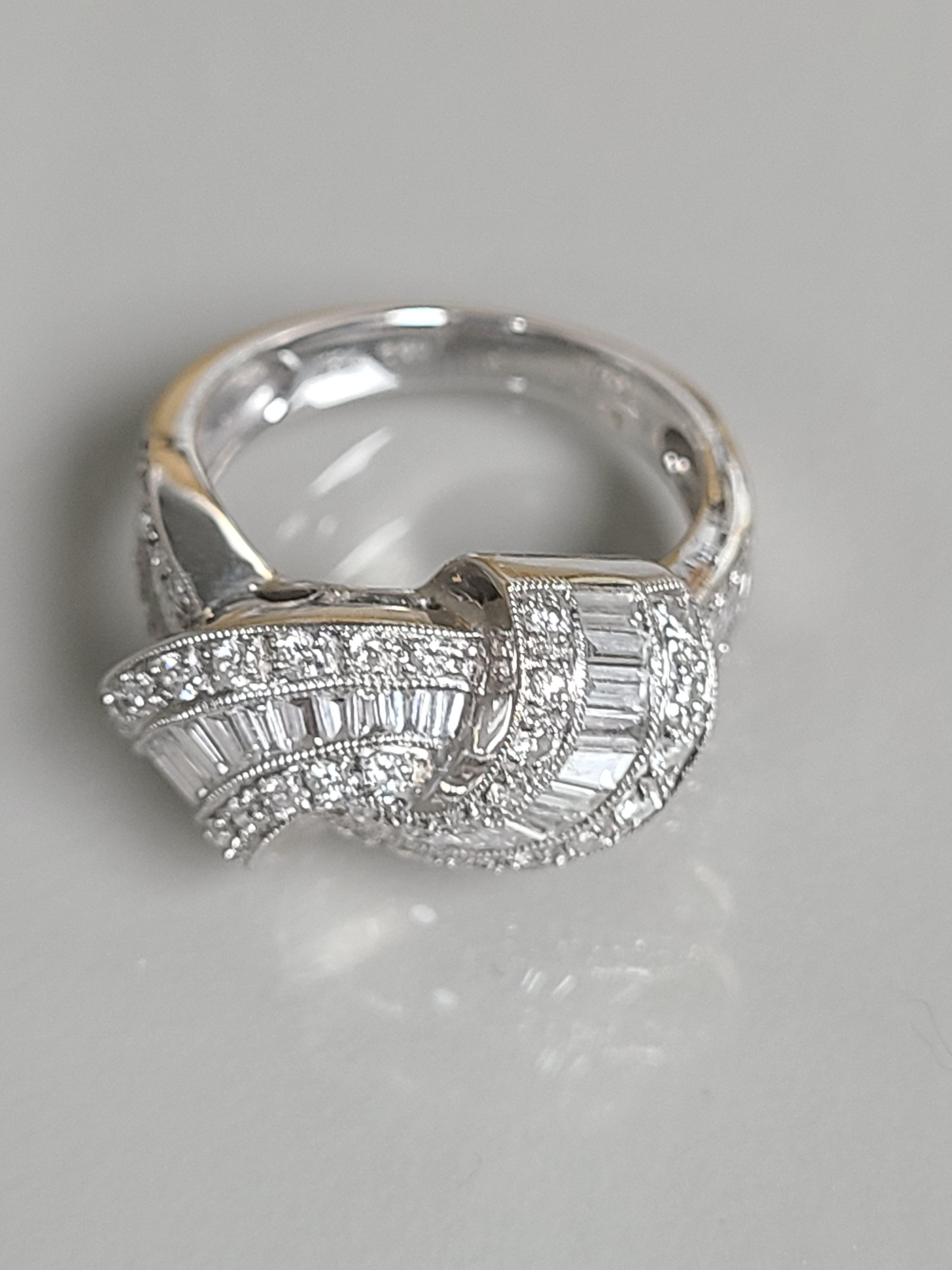 An Elegant diamond ring in art deco style made in 18k white gold. Combined diamond weight in the ring is 1.3 carats and gross weight of the ring is 6.2 grams. the ring dimensions in cm 1.2 x 2 x 2.2 (LXWXH). US size 5 3/4.