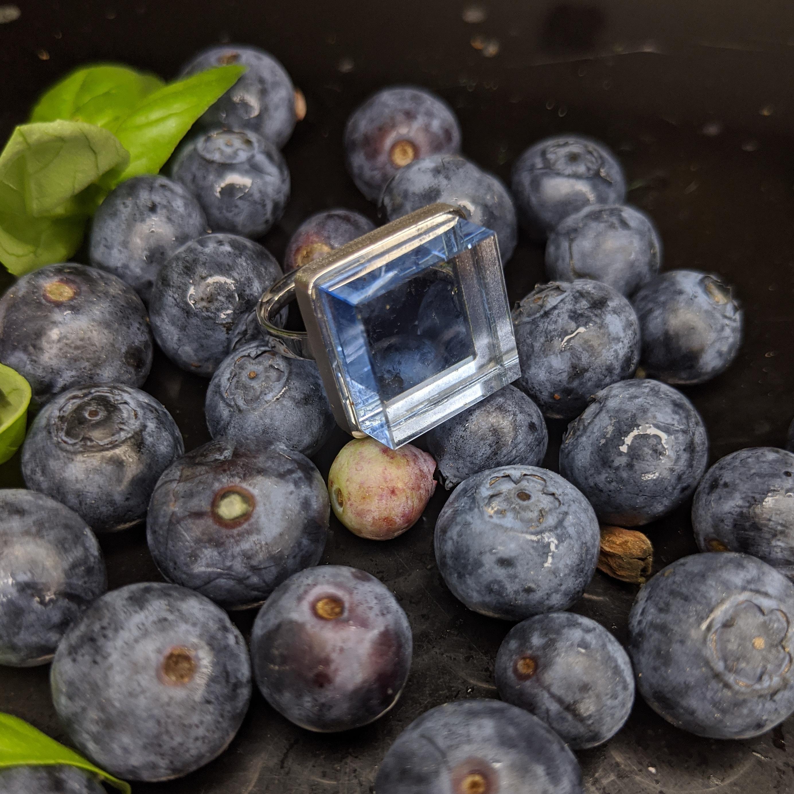 This ring is in 18 karat white gold with 15x15x8 mm grown blue quartz. It was published in Harper's Bazaar and Vogue UA. This piece can be personally signed. It will be packed as a gift. 

The ring reflects the art deco spirit and fits to women and