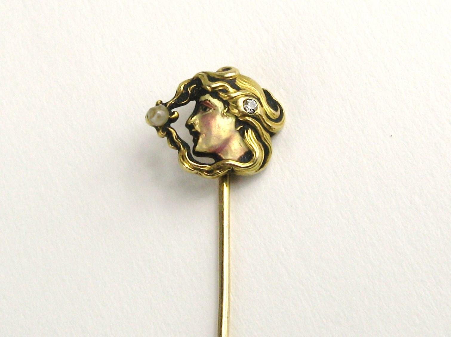 Stunning early 1910 18K Gold Art Nouveau Stick pin. Side profile on this lovely lady with a bezel set diamond in her hair. Seed pearl as well.  Enameled face. The face measues .52 in. x .43 in. The pin is 2.37 in. Please check our storefront for
