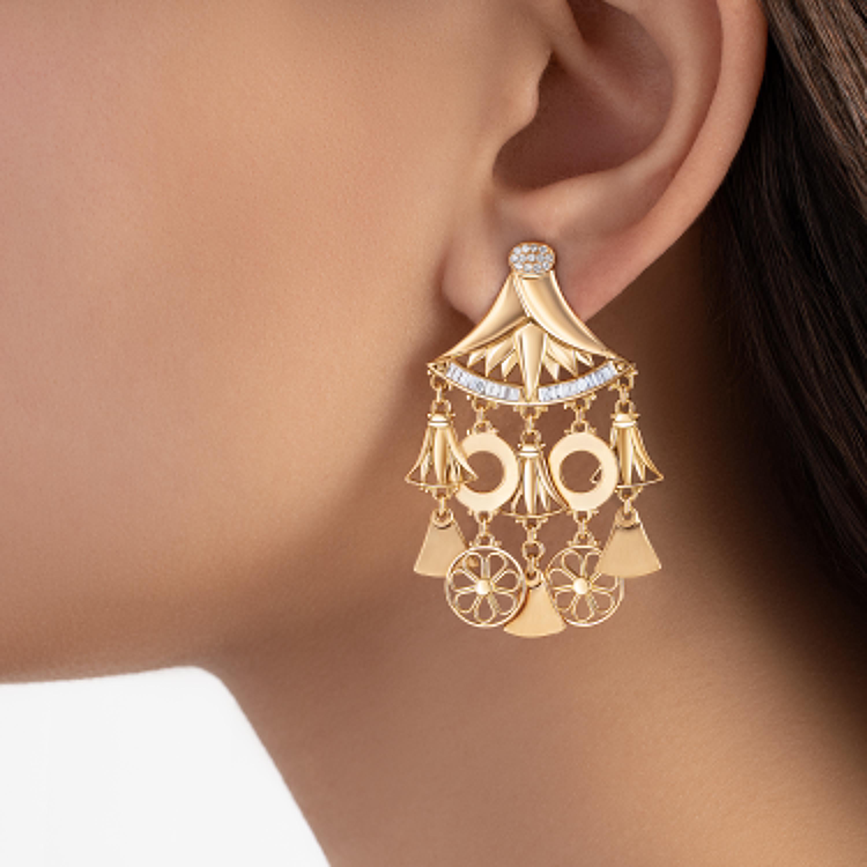 18 Karat Gold, Baguette-cut Diamond and pave-set Diamond Lotus Chandelier Earrings.
The radiant face of a fallaha (a woman of the Egyptian countryside) is marked by the sun from long, intimate hours spent with the land. Her jewellery speaks of her