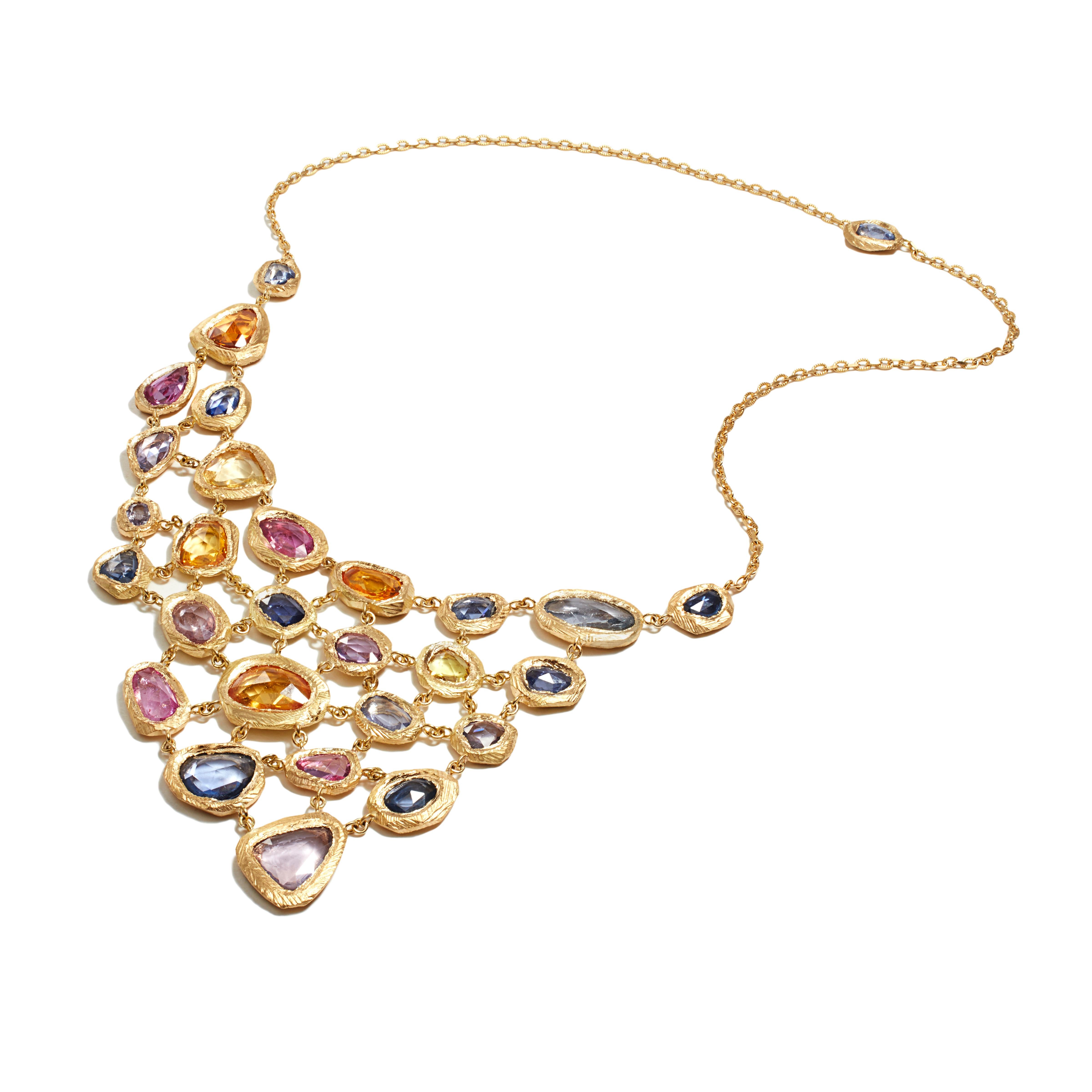 A one-of-a-kind bib necklace handcrafted by New York artist, Page Sargisson.  This necklace was made for a design contest at the Couture Show.  It has over 40 carats of sapphires including pink sapphires, blue sapphires, yellow sapphires, and