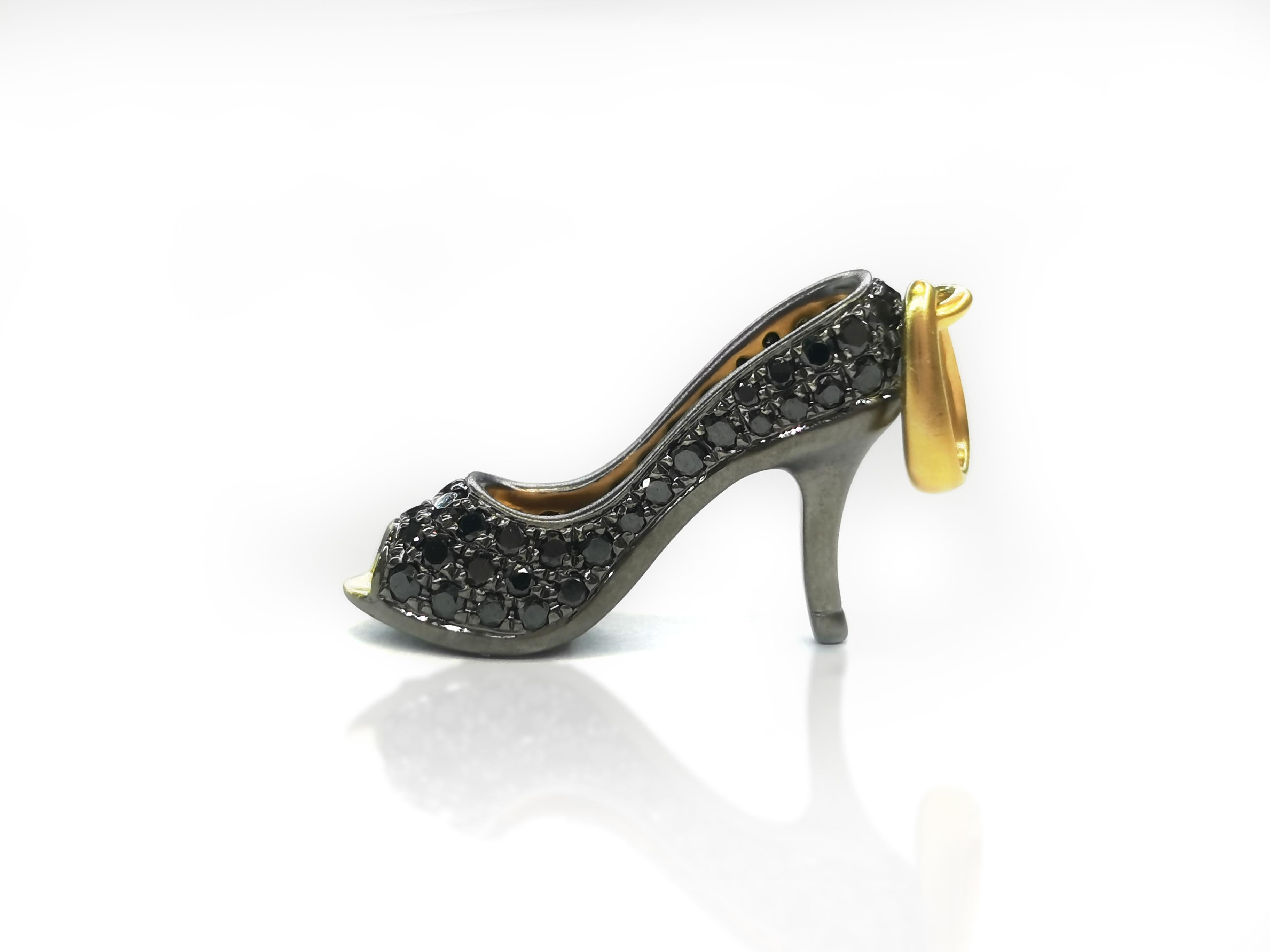 An elegant and very special high heel shoe pendant, set with brilliant black diamond weighing 0.36 carats, mounted in 18 Karat gold. 
O’Che 1867 was founded one and a half centuries ago in Macau. The brand is renowned for its high jewellery