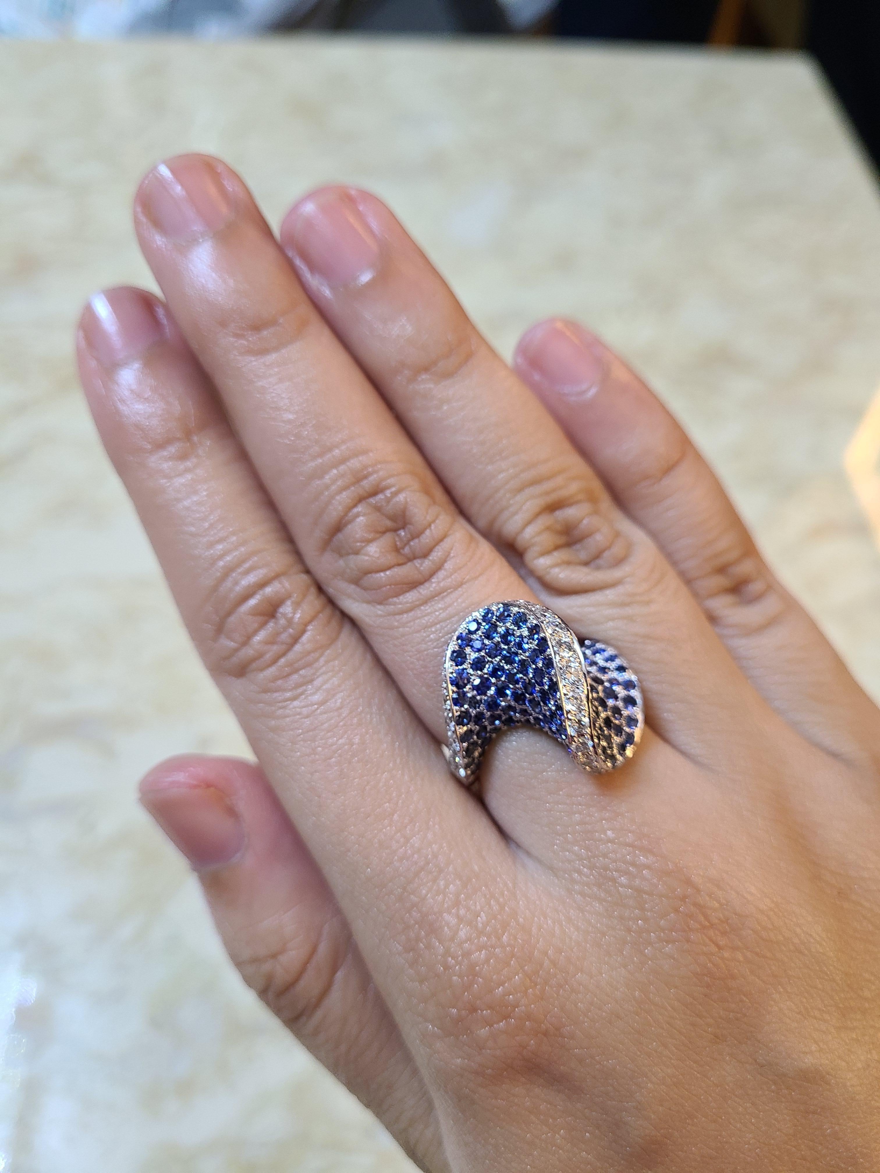 A modern and complex Ring design made in 18k white gold with blue sapphires and diamonds . The ring finish is high quality with exceptional craftsmanship . Complex design yet made easy to wear . The blue sapphire weight in the ring is 4.21 carats