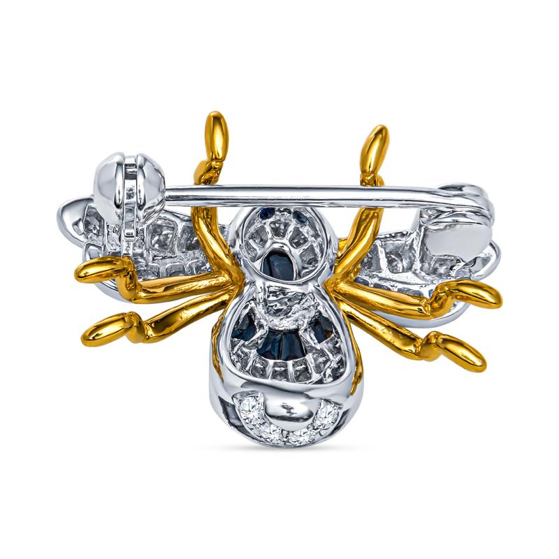 This sweet bumble bee brooch features 0.48 carat total weight in blue sapphires and 0.36 carat total weight in diamonds. It is set in 18 karat yellow and white gold. Wear alone or accessorize with other pins or place on your hat for a unique look.