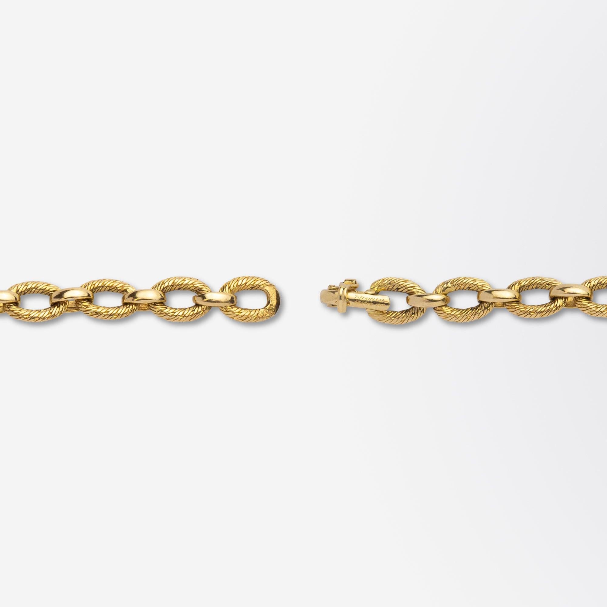 A fine 18 karat yellow gold bracelet manufactured by French goldsmith Georges L'Enfant for retail by Tiffany & Co. The bracelet features interconnecting links with oval 'woven' loops of fine 18 karat gold wire that are attached to simple gold jump