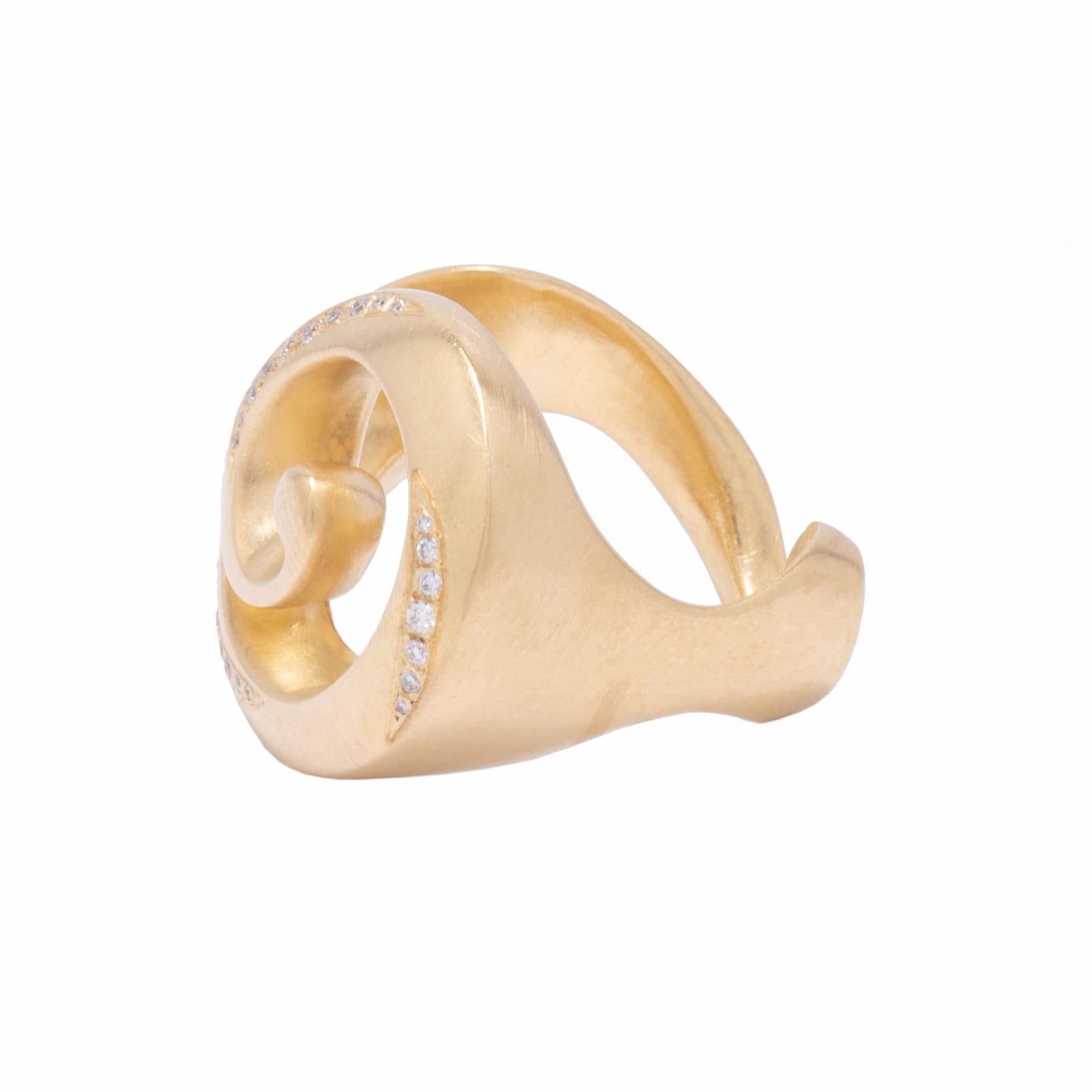 A perfectly sculpted swirl of 18 karat gold like a broken conch shell weathered from sand and seas is dusted with .48 tcw pave diamonds as remnants of sand. This hand carved Broken Shell Ring in 18 karat gold was crafted in our studio. While it is