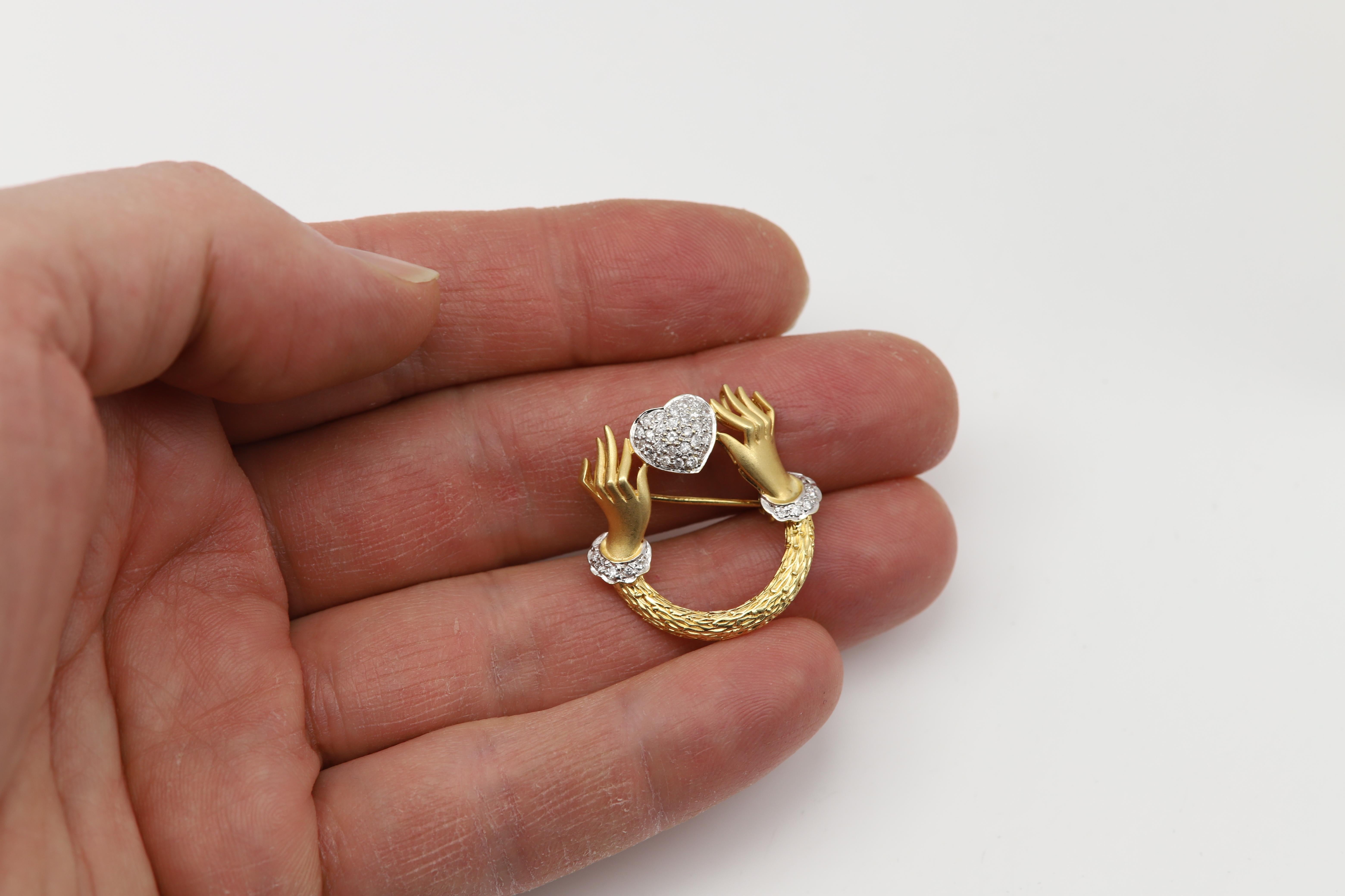 Vintage Diamond Brooch pin 
Two Hands Hold heart Design
18k Yellow Gold approx 5.1 grams
Circa 1960 pre-owned - very Good condition
Size: approx 1' inch 
Natural Diamonds approx 0.35 carat
Was bought from an estate Collection.
Appraisal certificate
