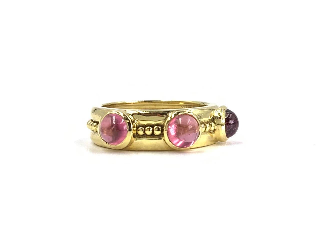 A well made 6mm 18 karat yellow gold high polished band style ring featuring three cabochon light pink tourmaline gemstones. Ring has beading engraving around the center. Great width band that can be stacked with other pieces or worn alone.
Finger