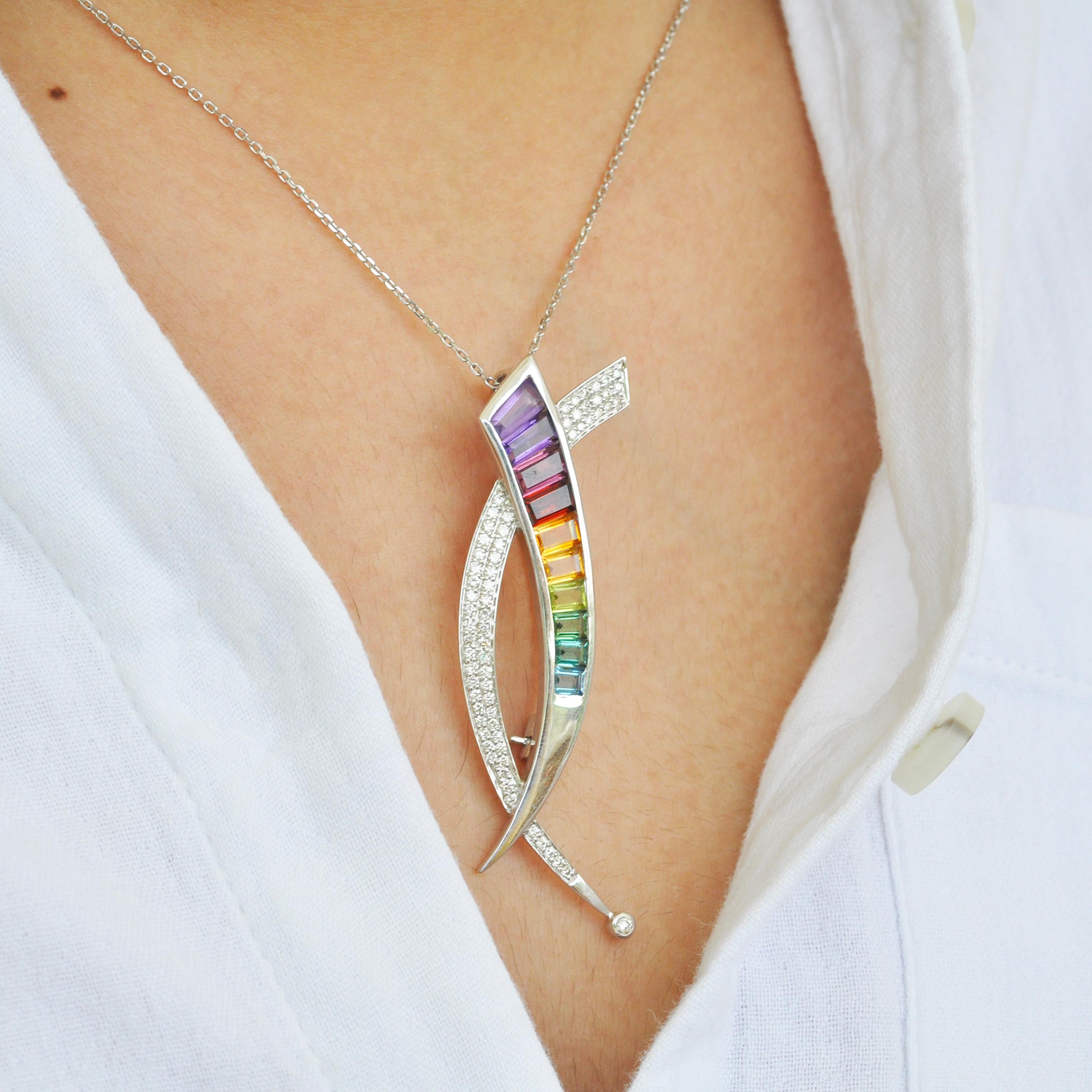 A sword shaped brooch is set in 18K Gold, which can also be worn as a pendant. The pendant brooch features exotic natural gemstones like Amethysts, Garnet, Rhodolite, Tourmaline, Citrine, Peridot and Topaz, perfectly taper cut and channel set,