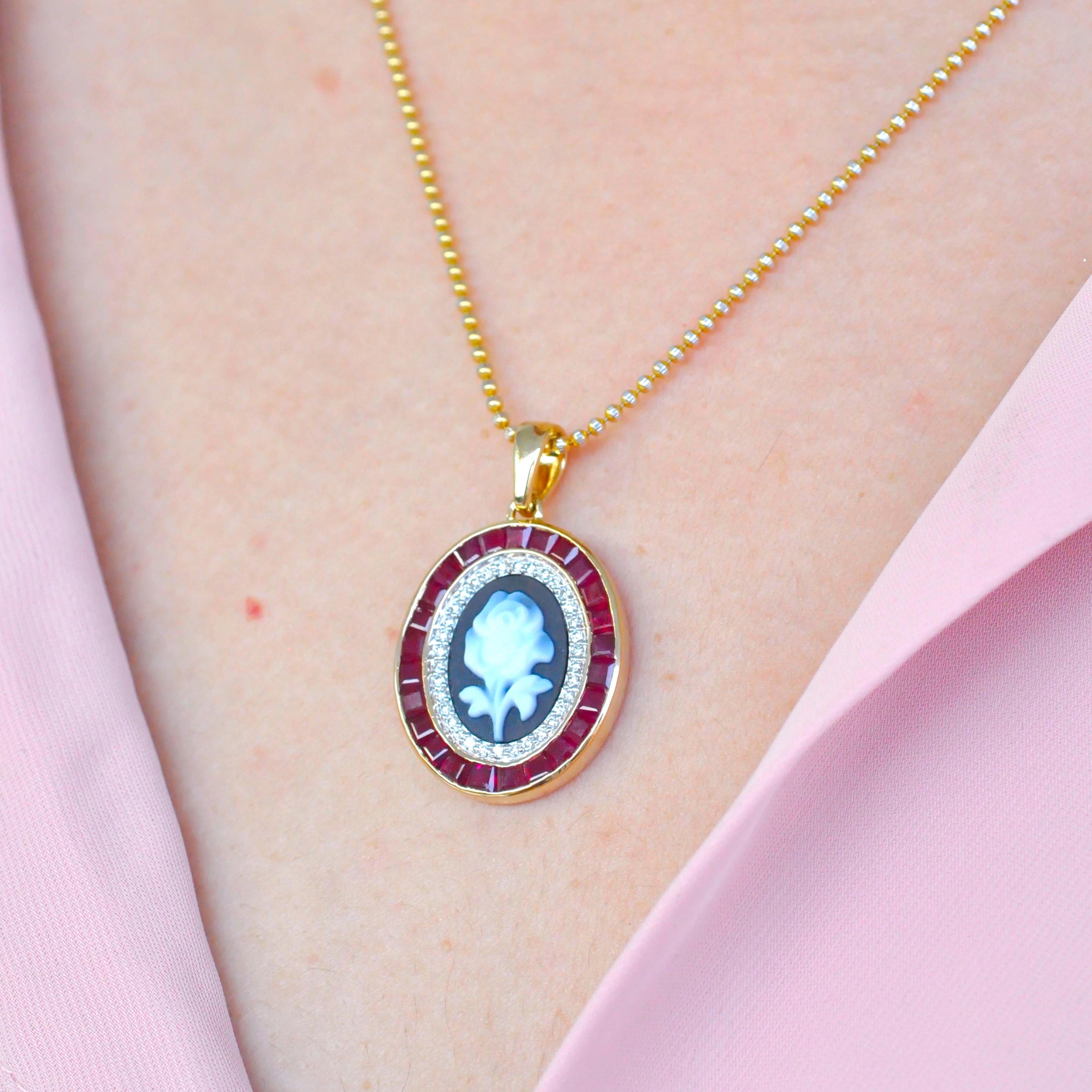18 karat gold calibre cut burma ruby diamond rose agate cameo pendant necklace.

This beautiful contemporary pendant necklace set in 18k yellow gold features an intricately carved rose cameo by a german cameo artist sitting at the centre. Surrounded