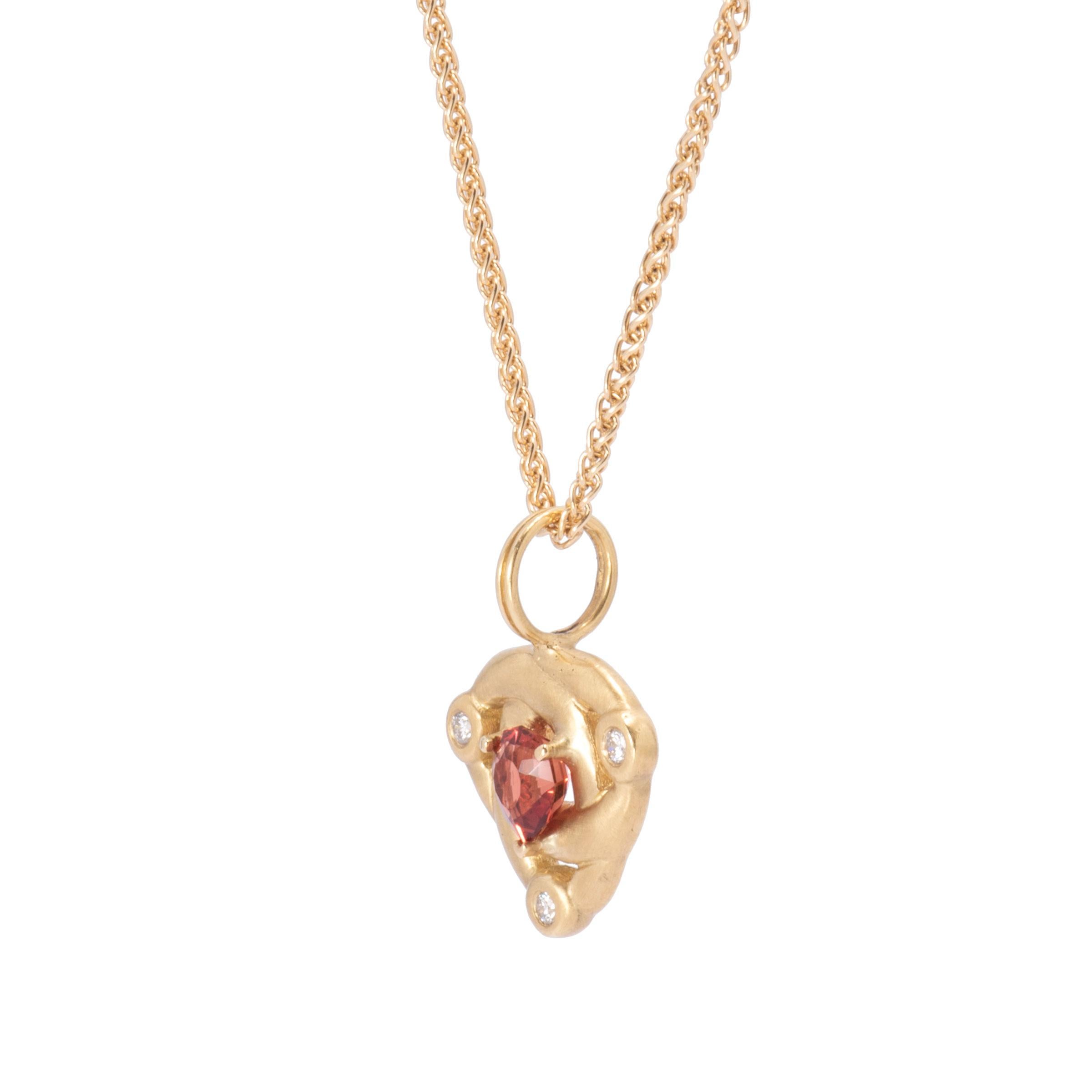 A glorious deep Sunstone weighing 1ct. is prong set in the center of this 18 karat gold Celtic Knot Pendant. Three round white diamonds pay court to this fabulously rich cranberry sunstone. The Celtic Knot is formed by 3 interwoven loops that have