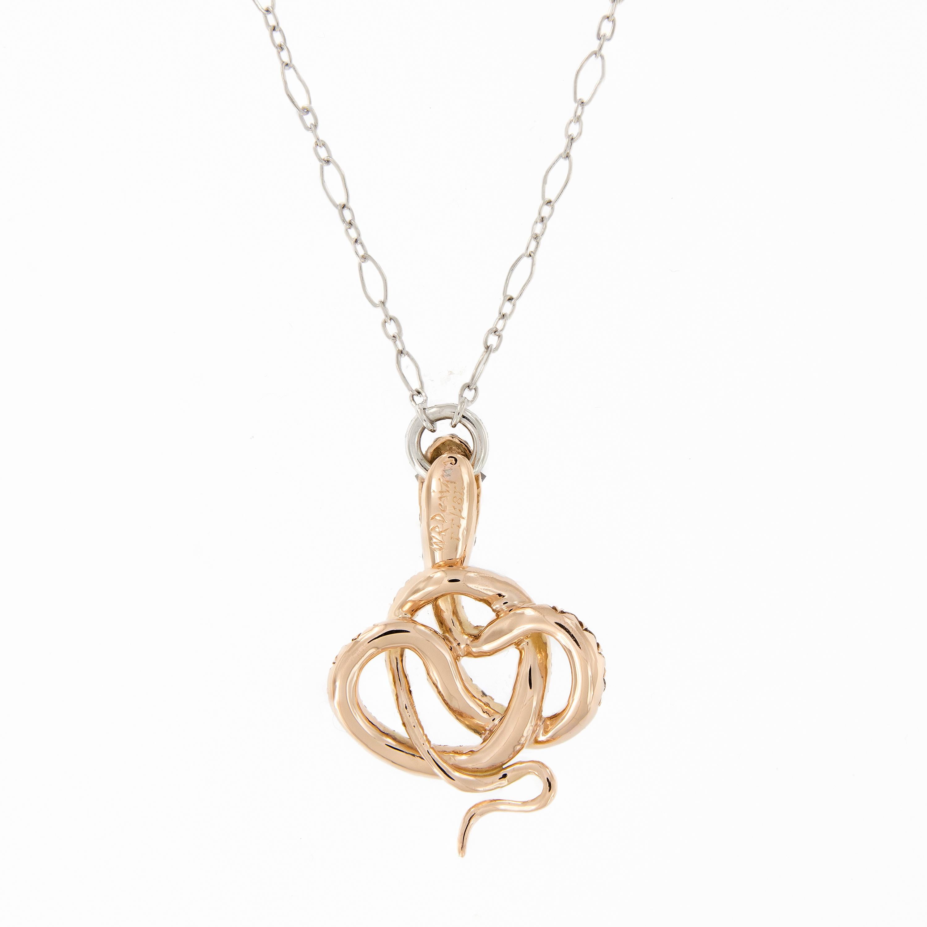 This unique diamond snake pendant is certain to delight. This Serpent is crafted in 18k white and rose gold and shimmering with champagne diamonds. The snake pendant suspends from a 16.5 inch long hand-fabricated platinum chain. Pendant measures .86