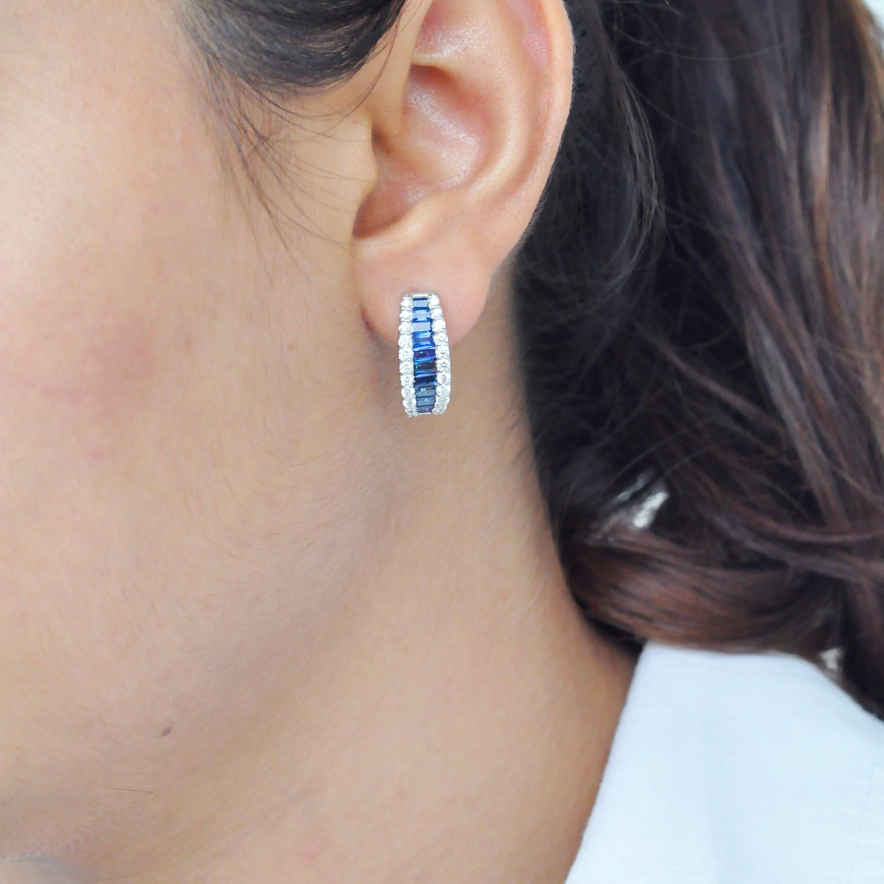 18 karat gold channel set blue sapphire baguette diamond huggie hoop earrings

This royal blue sapphire mini-hoop is stunning. The perfectly cut baguette-cut sapphires tapering towards the ends in a channel setting are incorporated within an