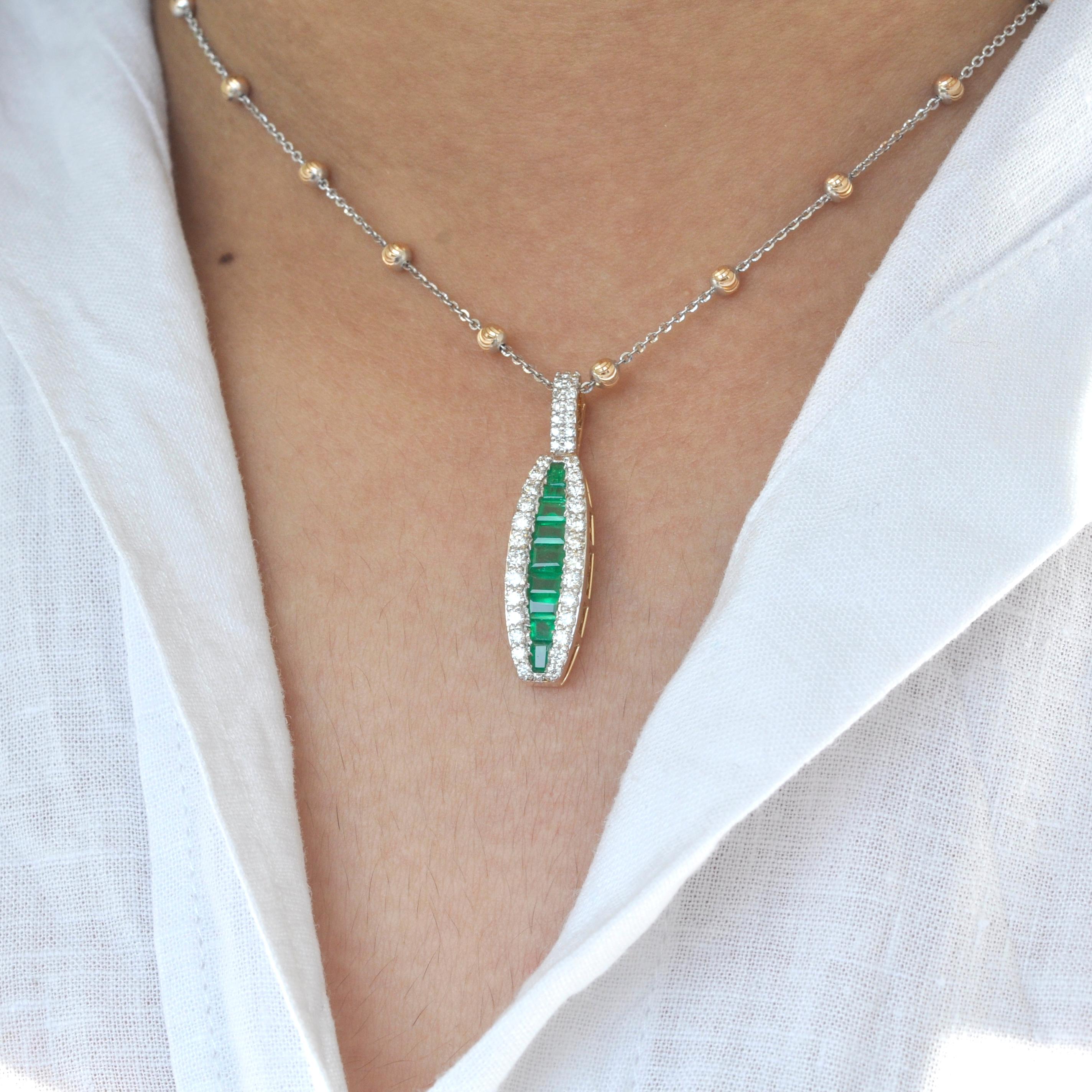 18 karat gold channel set emerald baguette diamond linear pendant necklace

The enchanting pendant with the natural emeralds incorporated within an equivalent layer of micro pave set diamonds on either is distinctive in its very form. The