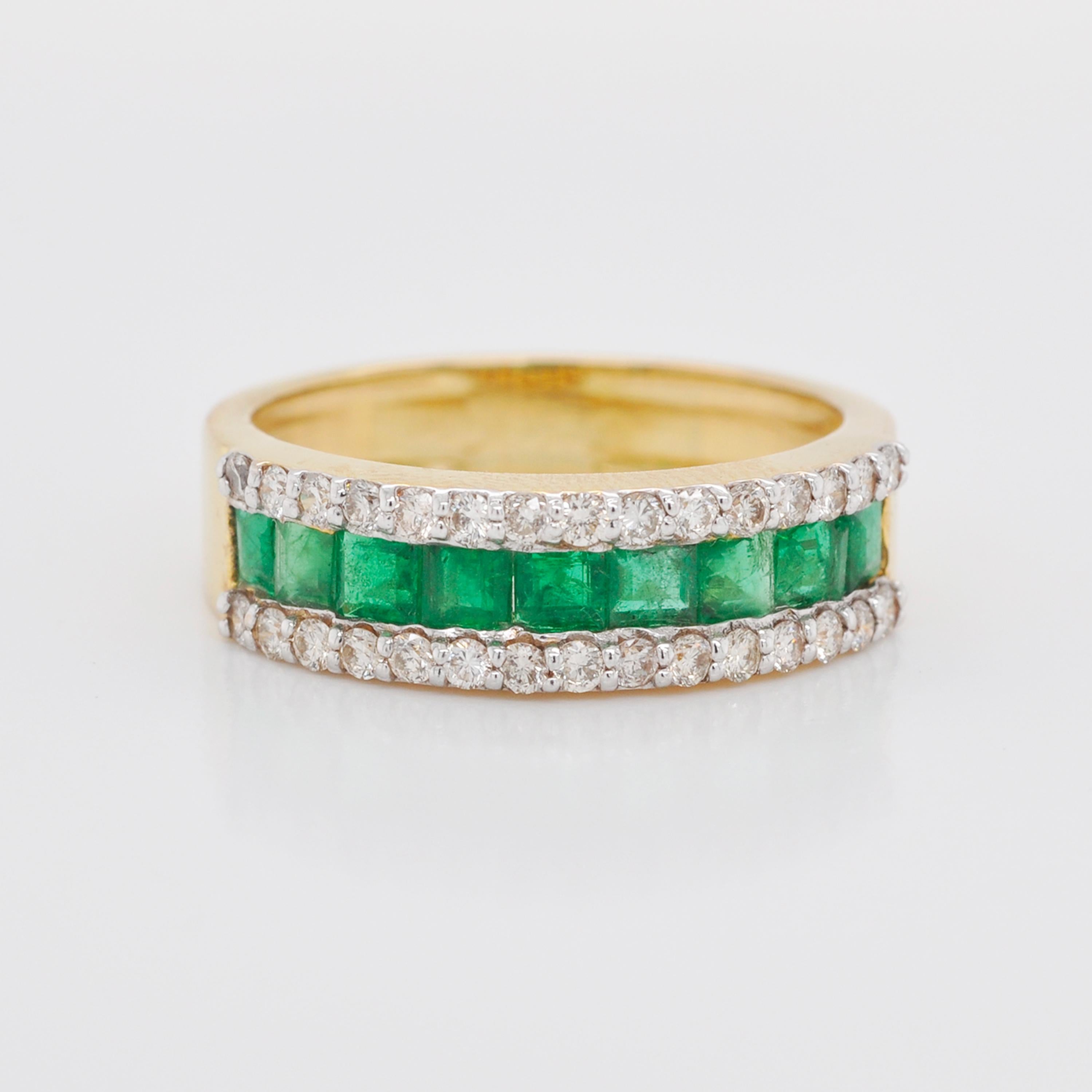 emerald cut center stone with gradient emeralds in a channel set band