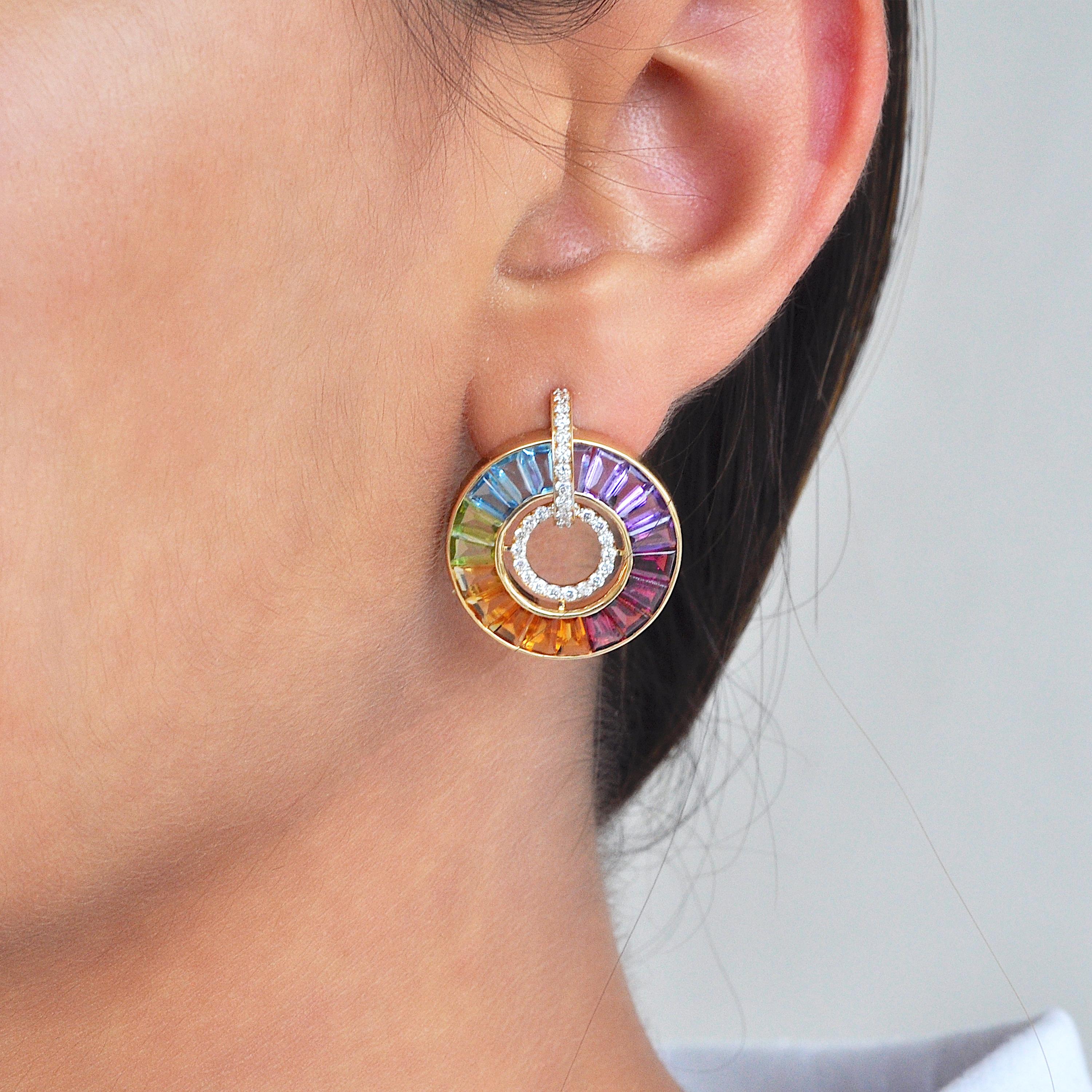 14 karat gold channel-set rainbow baguette gemstones diamond circle earrings.

Our 14k gold rainbow channel-set diamond earrings are a dazzling display of vibrant colors and sparkling brilliance. Crafted with meticulous precision, these earrings