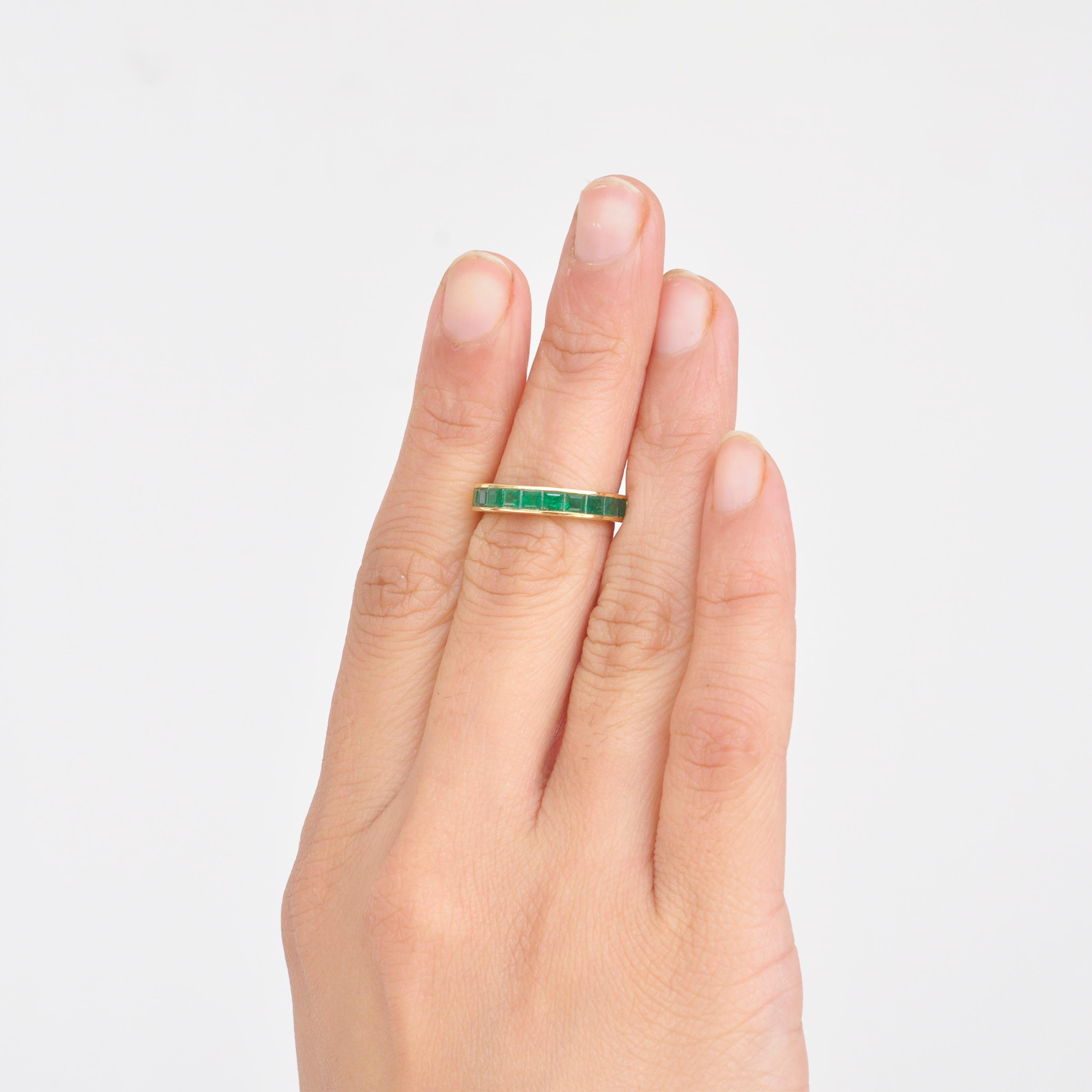 18 karat gold channel set zambian emeralds square band ring.

A classic 18 karat gold contemporary band has channel set zambian emerald baguettes. The natural emerald  baguettes used are lustrous and the quality is excellent. This ring is a treat