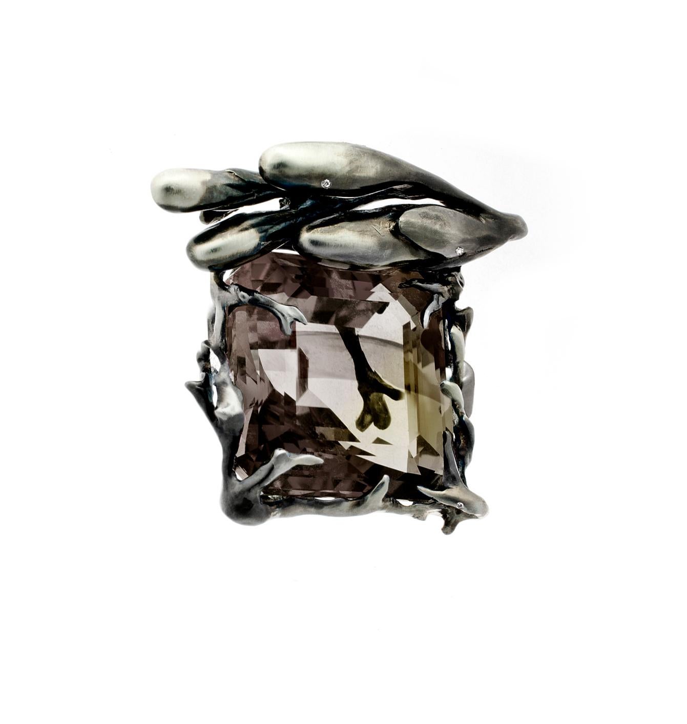 This contemporary ring in 18 karat black gold with diamonds and a large smoky quartz (octagon) was featured in a published issue of Vogue UA. This piece can be personally signed.

The ring features four white round diamonds and a large smoky quartz