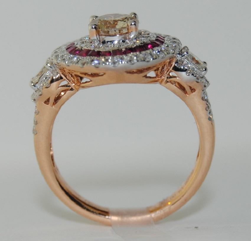 Ladies Round Center Fancy Diamond/Yellow Ring with Brilliant Cut White Diamonds total weight 1.55 Carats, surrounded by small Rubies weighing 0.56 Carats.  The Ring is made of 18 Karat Rose Gold, Size 6.5   