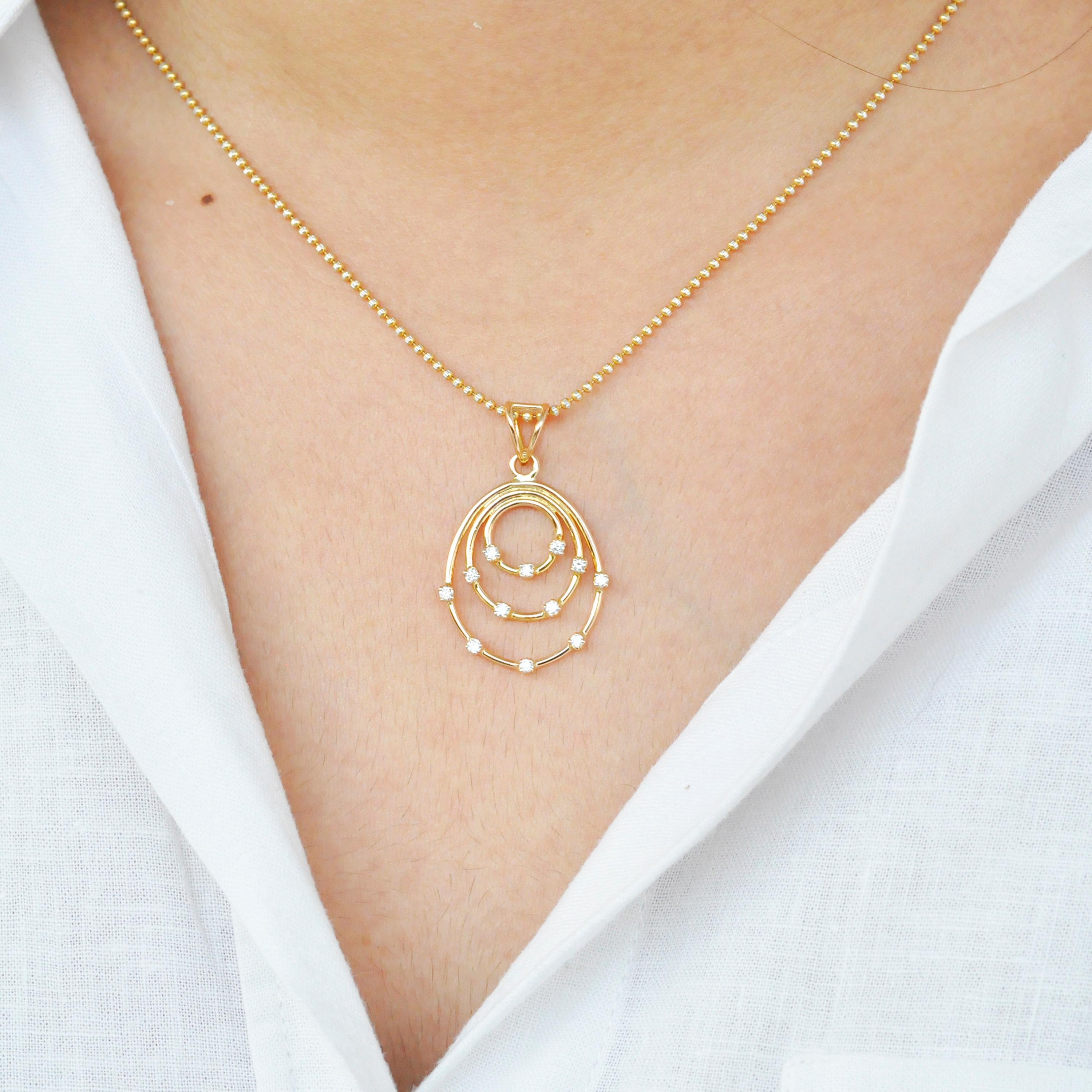 The beauty of this pendant lies in the simplicity of its construction. Concentric circular and oval gold rings with sprinkles of diamonds on it adds to the elegant beauty of this pendant. Perfect to be worn daily, this pendant will always feel