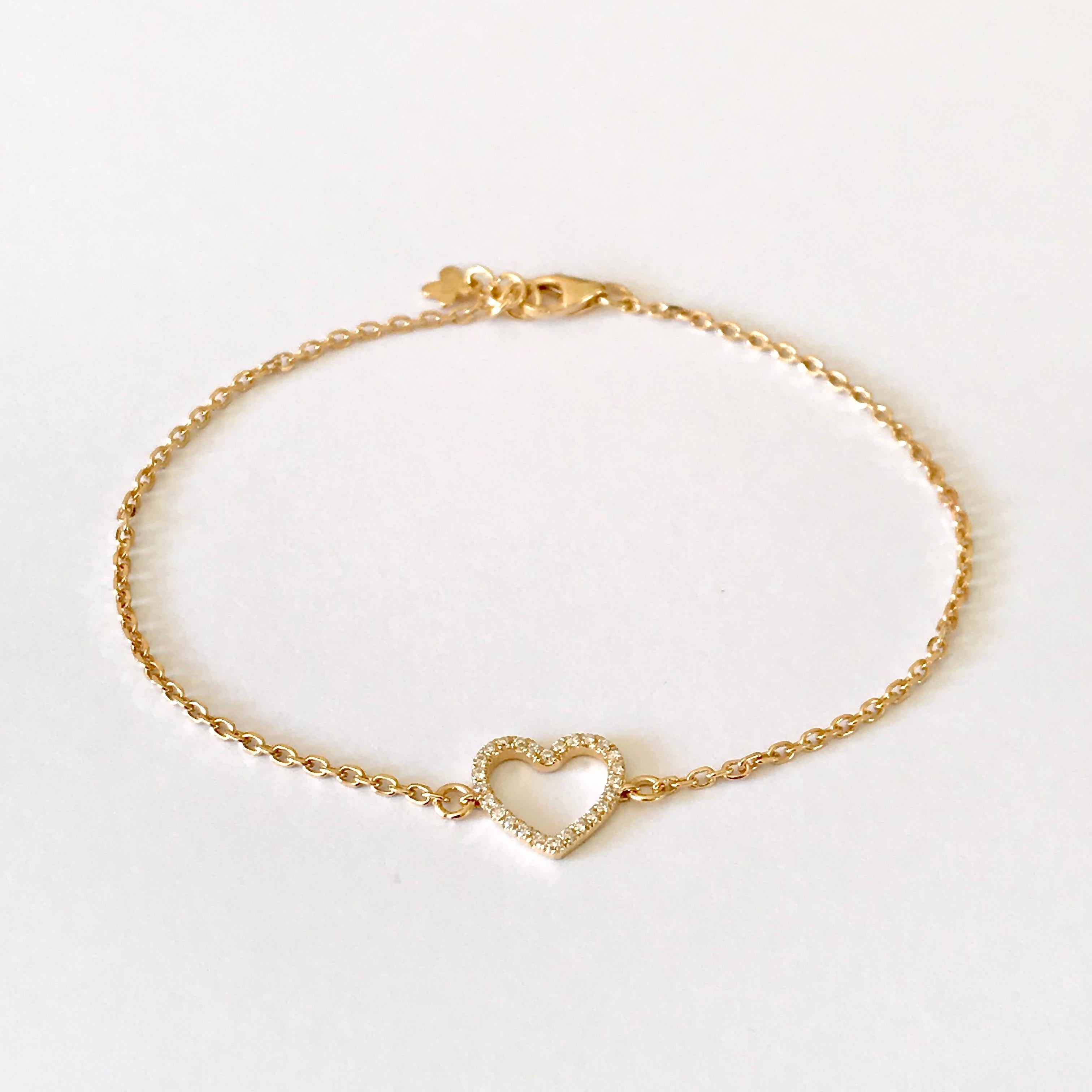 This heart bracelet is made of solid 18Karat gold and is set with high-quality white diamonds.
Length: 18.50 cm ( adjustable different lengths ) 
Total Diamond Carat Weight: 0.11Ct  (26 ) 
Heart’s Width: 1.00 cm
Hallmark: London Goldsmith's Company