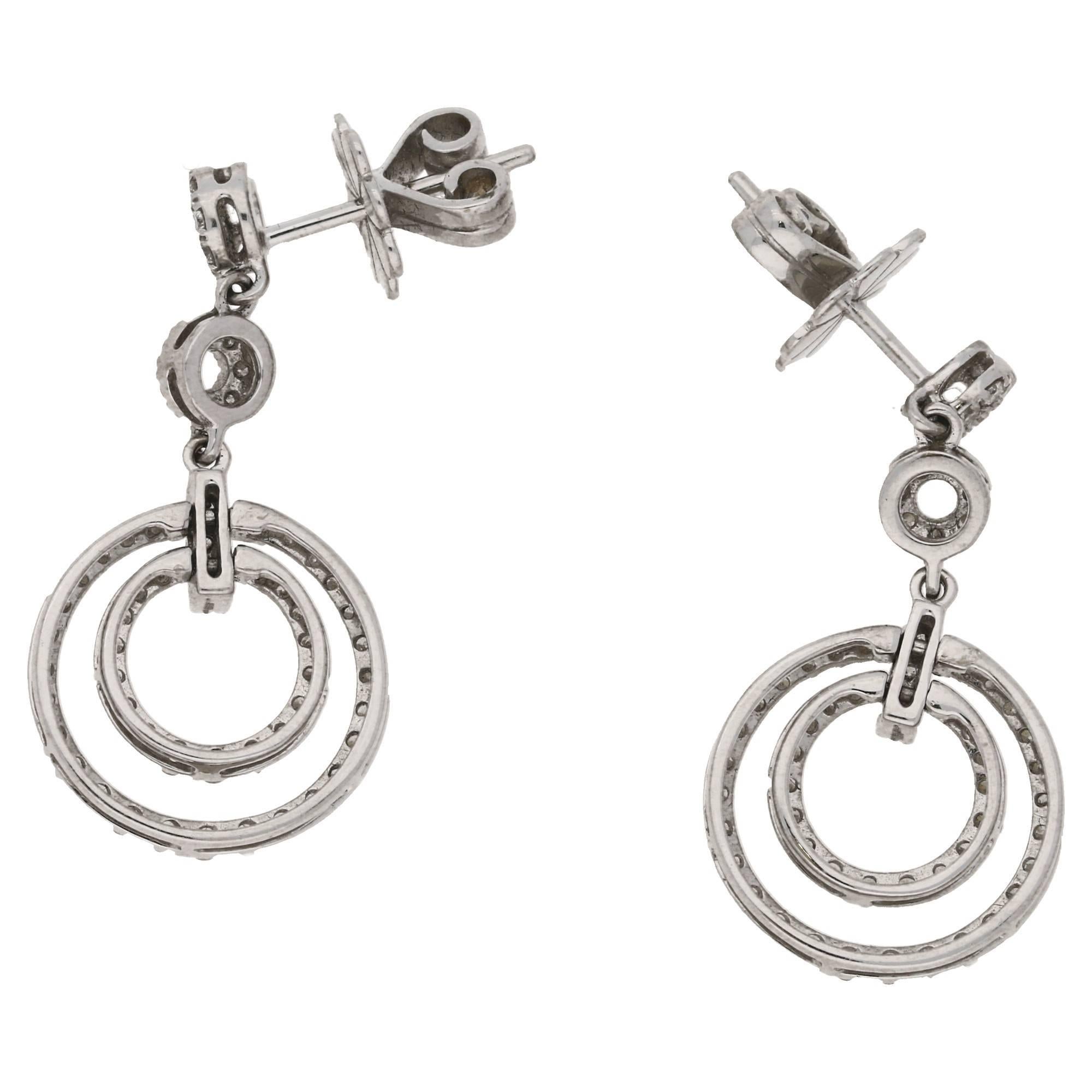 A pair of ravishing circle drop earrings with diamond pavé detail. With two large intersecting circlets channel and grain set hung from two further articulated diamond set circles. On post and butterfly fittings. Estimated total diamond weight: