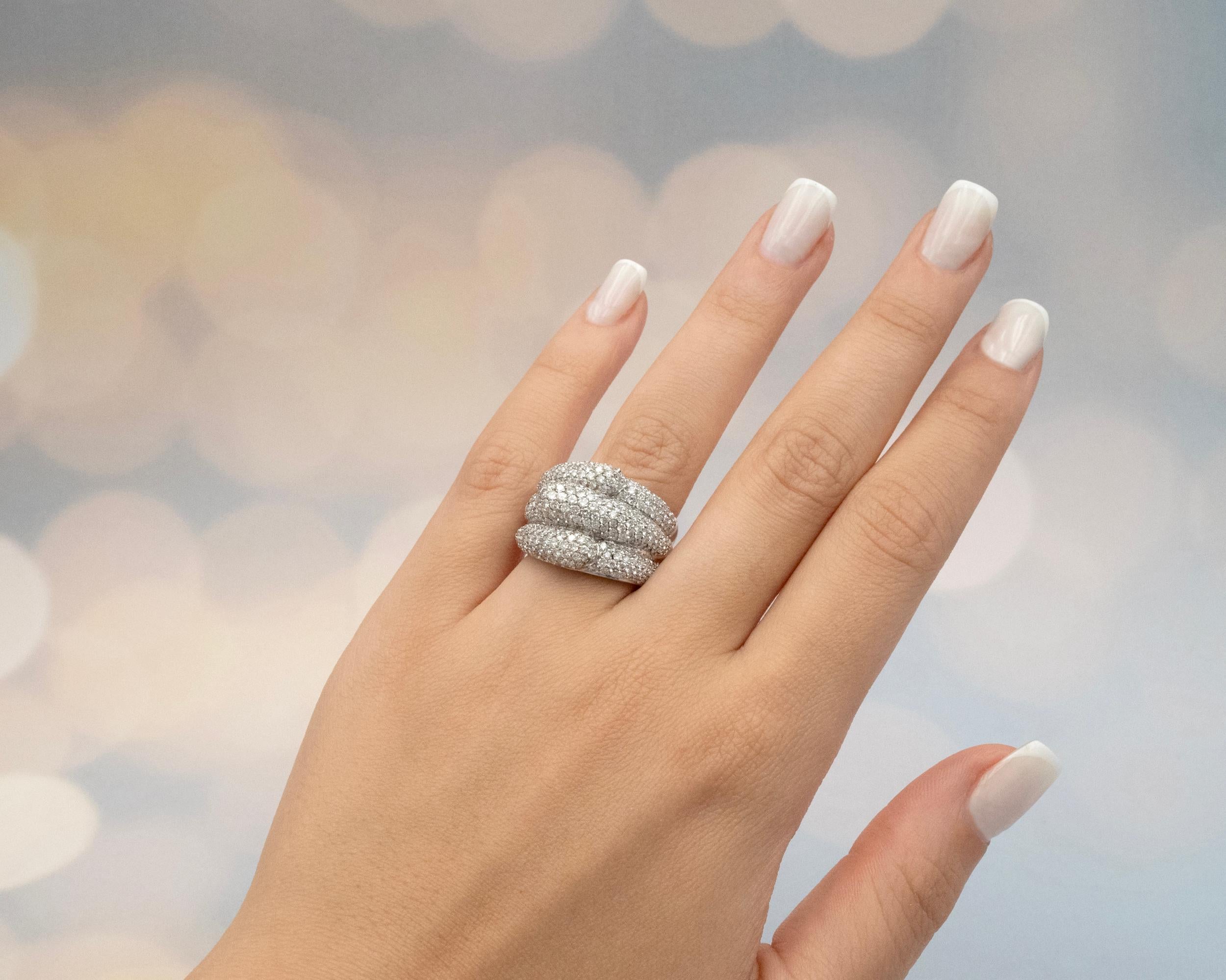 Introducing our stunning Dome Ring in 18 karat white gold, adorned with total of approximately 3.35 carats delicately paving three ridges ( with alternate directions), creating an enchanting sparkle from every angle. 
This extraordinary piece