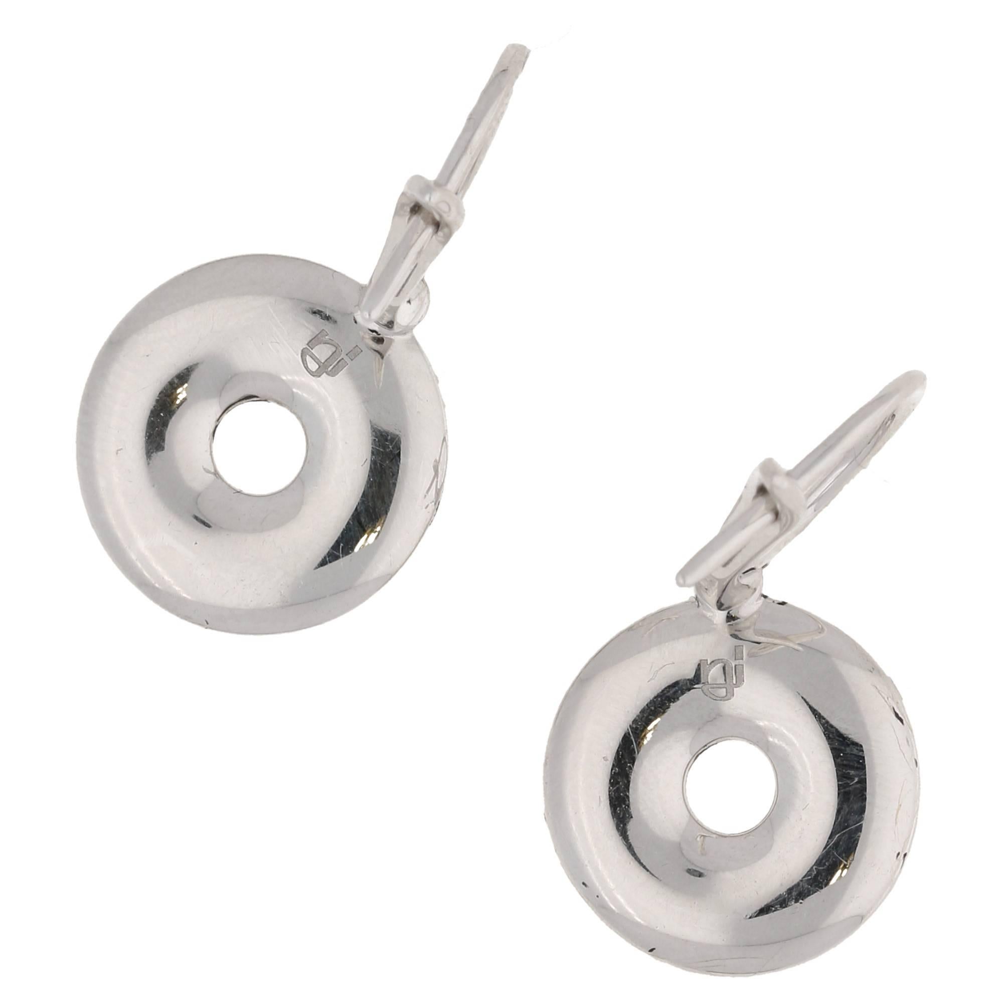 A modern pair of 18ct white gold diamond disc shaped drop earrings featuring a black enamel border and pave set round brilliant cut diamonds to a French continental fitting. Total diamond carat weight estimated as 1.25ct, G/H colour and Vs