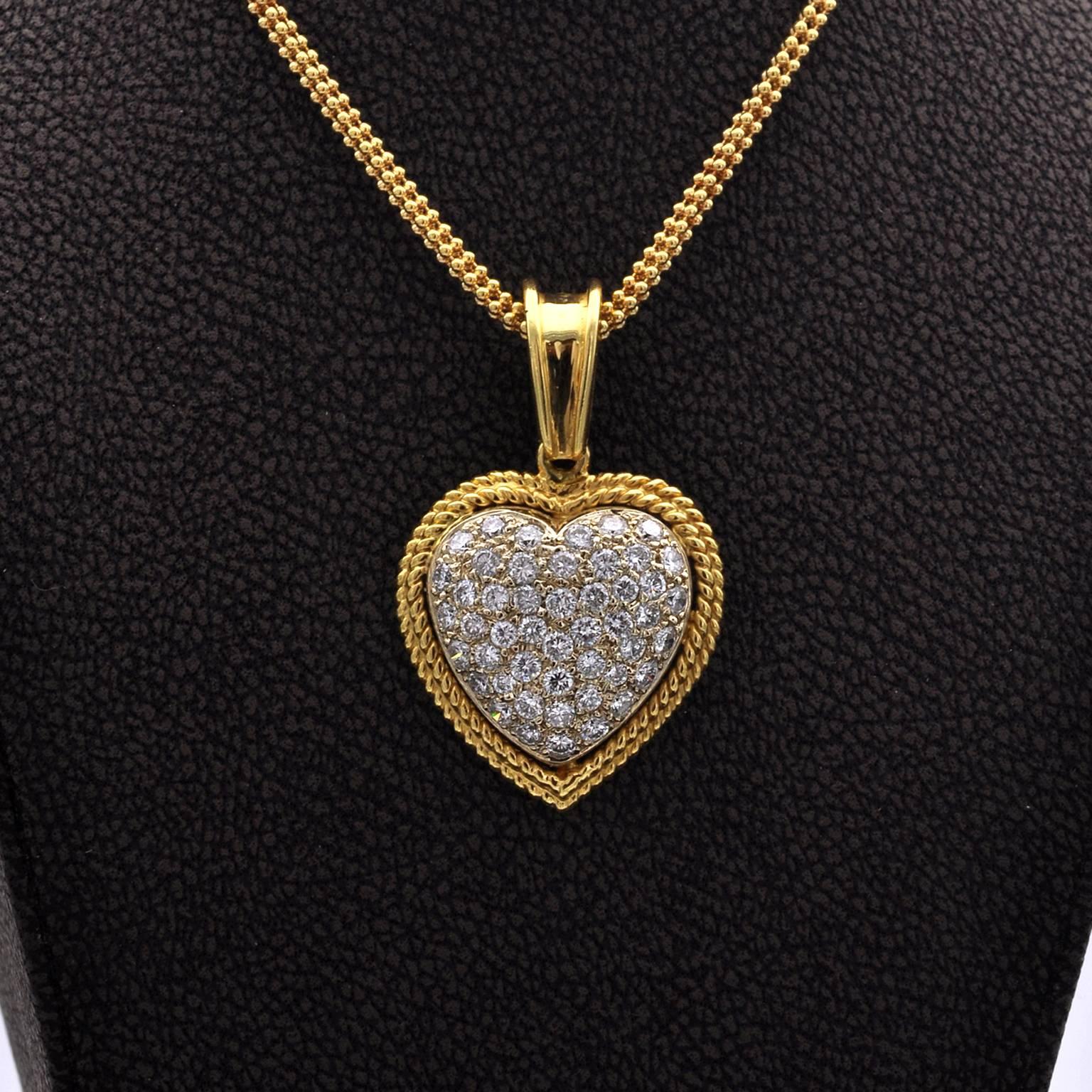 Charming 18 Karat Gold gold and diamond heart pendant.  A domed white gold 