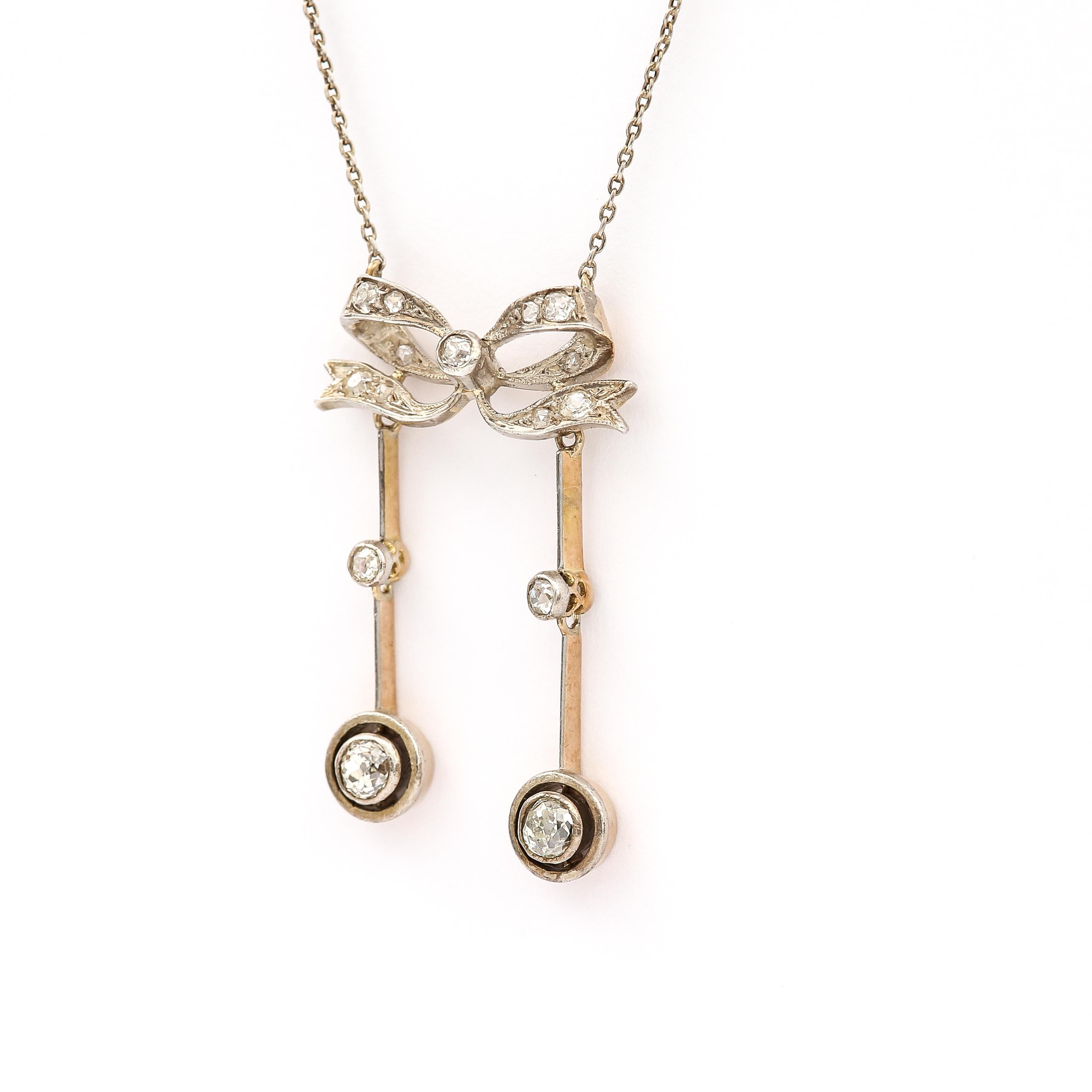 A charming Edwardian negligee diamond pendant, regarded as such because negligee or in French deshabille alluded to the sheer gown worn by ladies during this era. A negligee pendant usually consists of two unequal drops which gives this antique