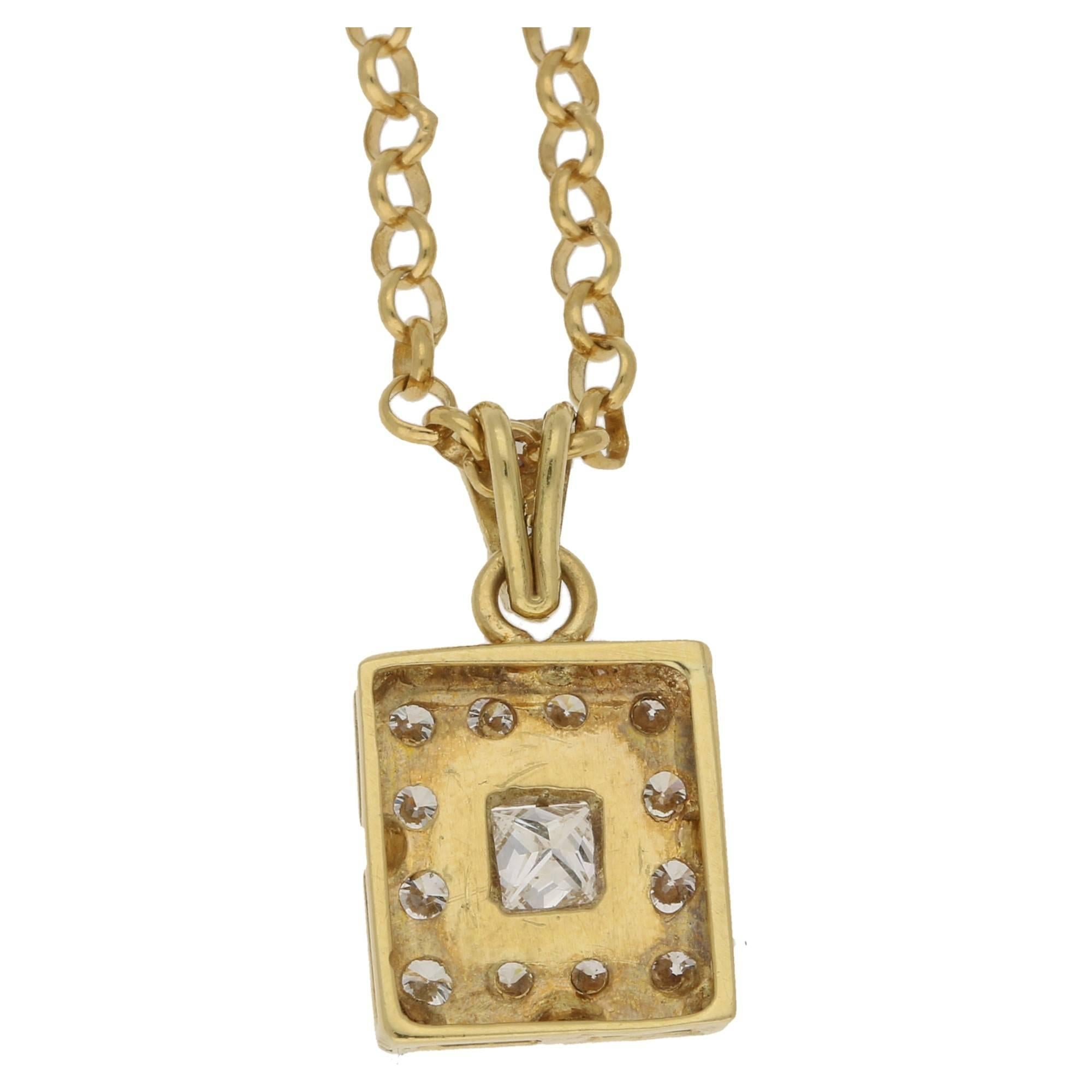 A quirky 18k yellow gold and diamond pendant on chain. The central princess cut diamond measures 0.3cts, is F-G colour and has a clarity of VS. This is surrounded by 0.5cts of round brilliant cut diamonds also F-G, VS clarity. Hallmarked 750. The