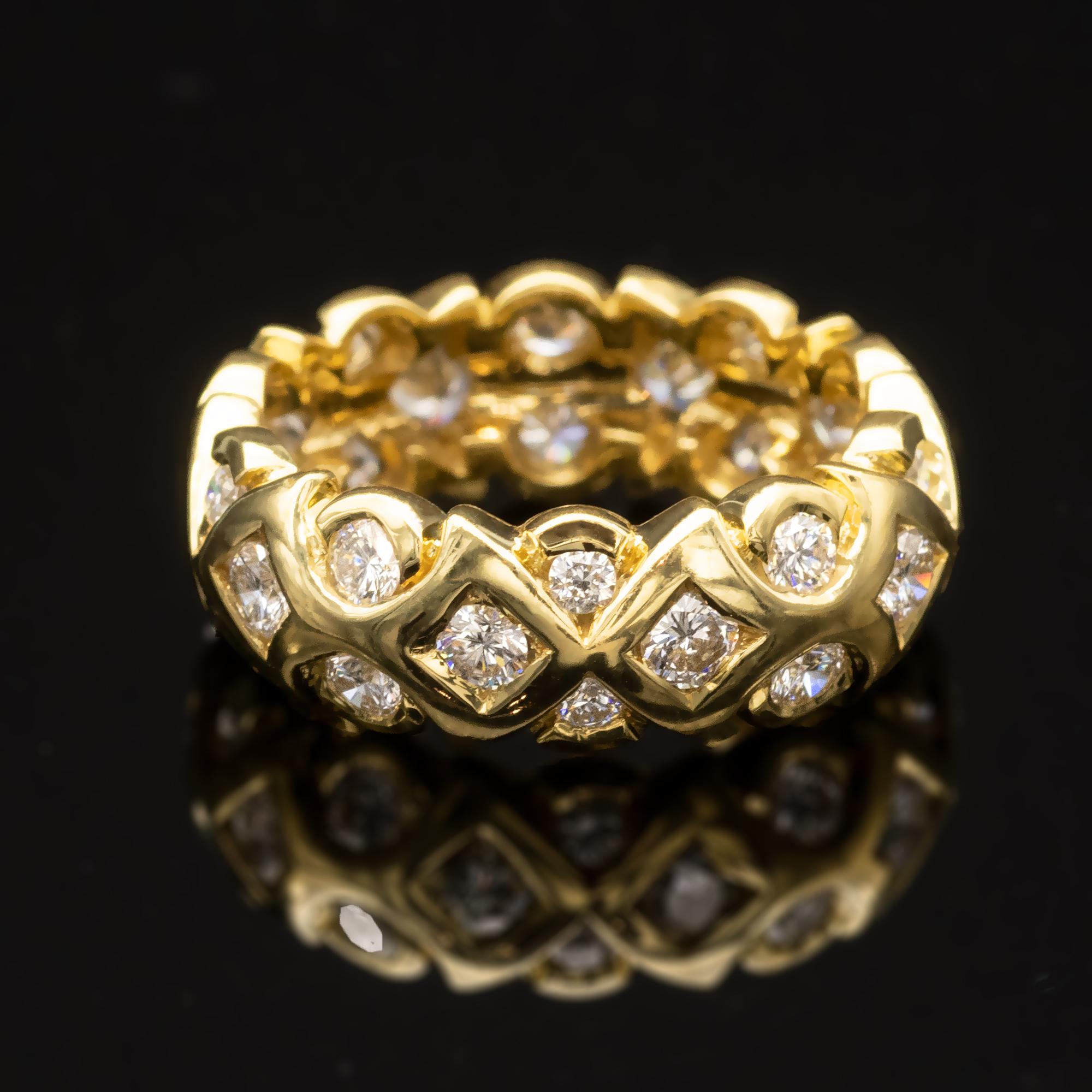 Graceful designer yellow gold wedding ring in which three rows of top quality diamonds are nested in modern arabesque like motives.
Details:
Diamonds: 1.68 carat F/G VVS/VS
Total weight: 8.10 grams  
18 KT french state hallmark stamp
Width: 6.5 mm
