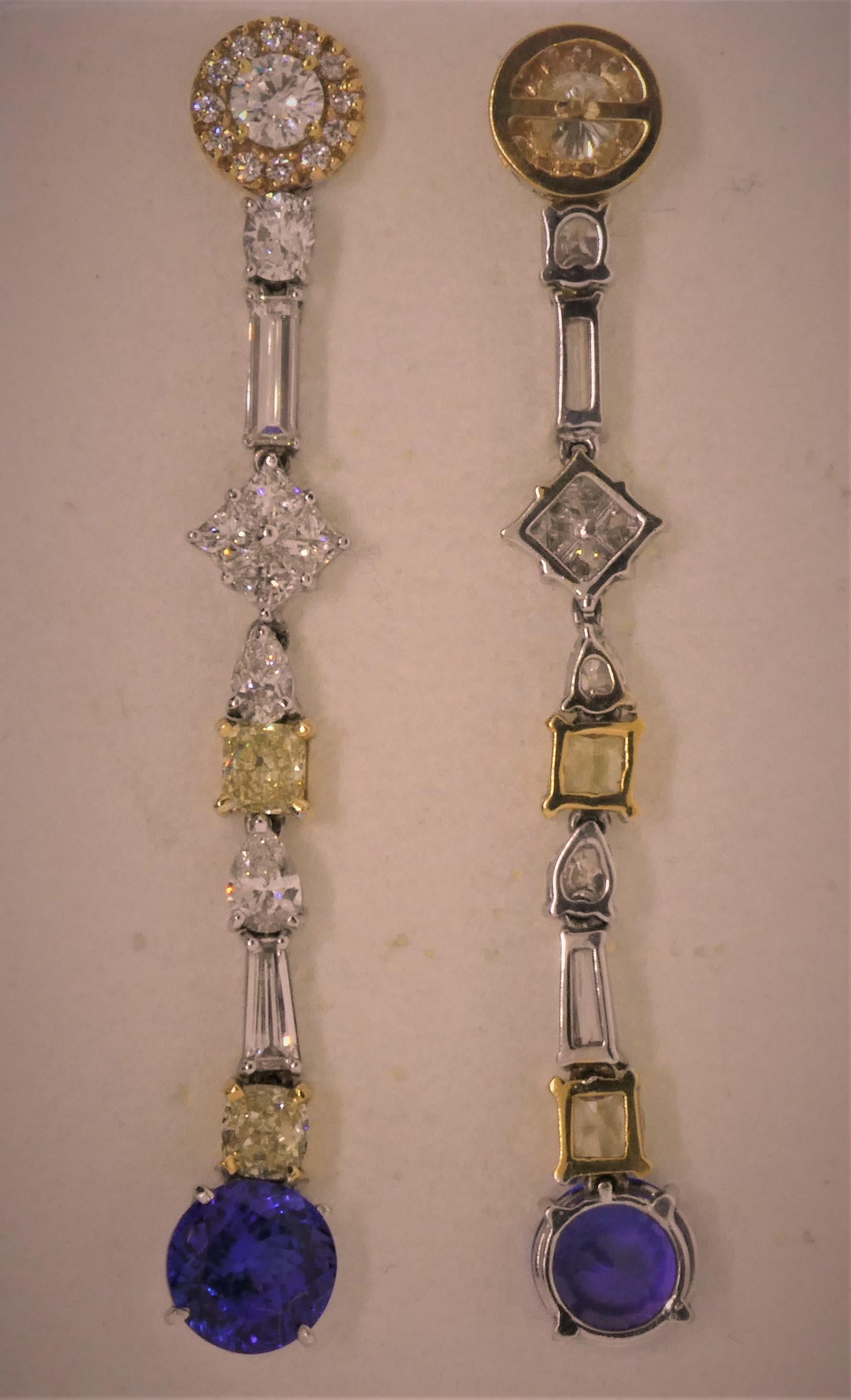Creator and designer Michael Engelhardt blends white and yellow gold, yellow and white diamonds of all shapes, and a lovely pair of Tanzanites to make this unbelievable and interesting pair of chandelier earrings.  The two top clusters contain a