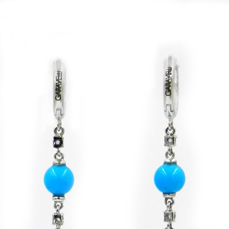 18KT White Gold BLUE SAPPHIRES and TURQUOISE GARAVELLI LONG EARRINGS 
Total lenght cm 8 , inches 3.15
18kt GOLD gr  : 5,50
BLUE SAPPHIRES  : 0,20
TURQUOISE total ct : 26.51