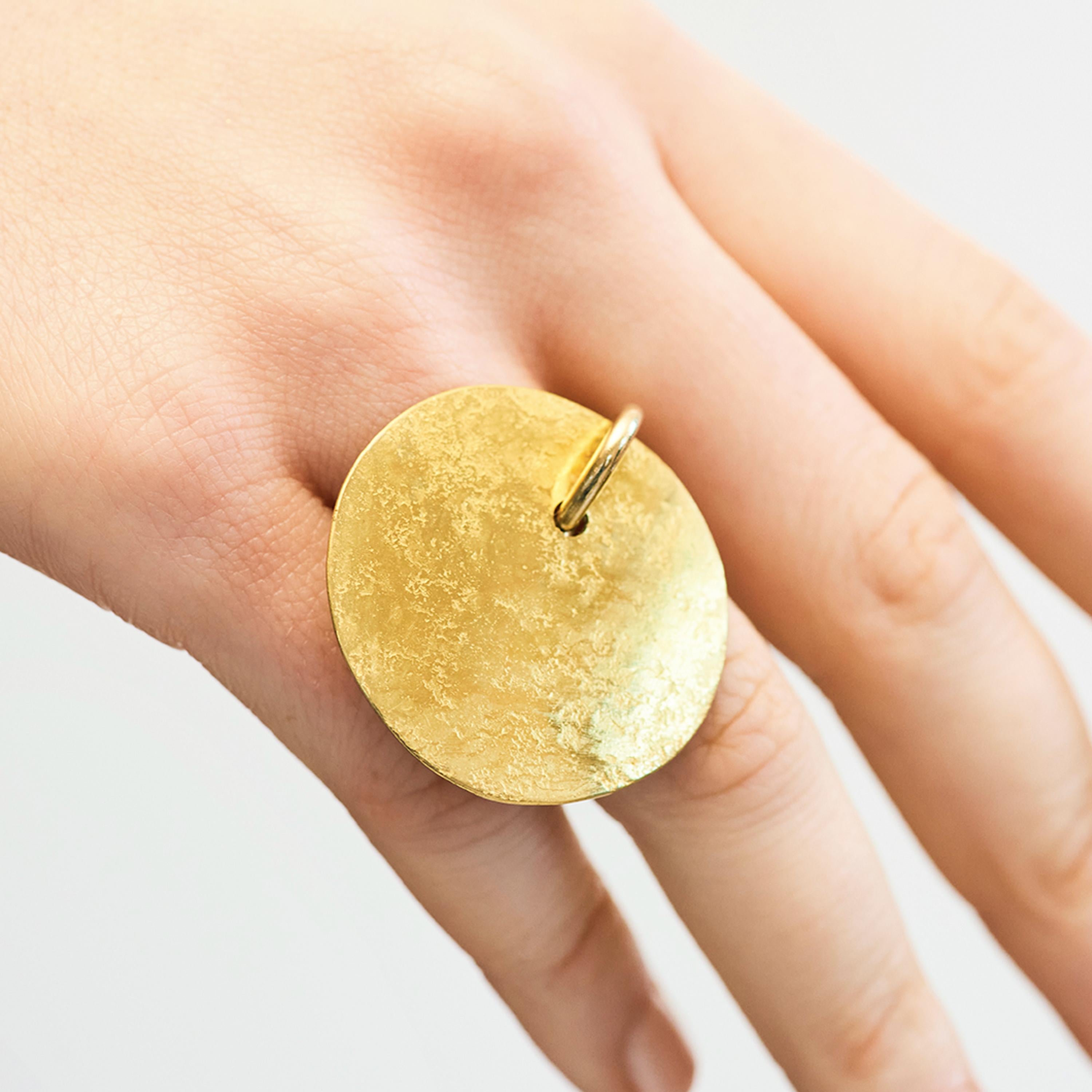The simple circular shape of Catherine Le Gal’s Disk ring is a canvas of rich texture. The shank of the ring is crafted from 18 karat gold, creating a beautiful texture and shade of gold. This ring is a size 54. 

Catherine Le Gal likes contrasts,