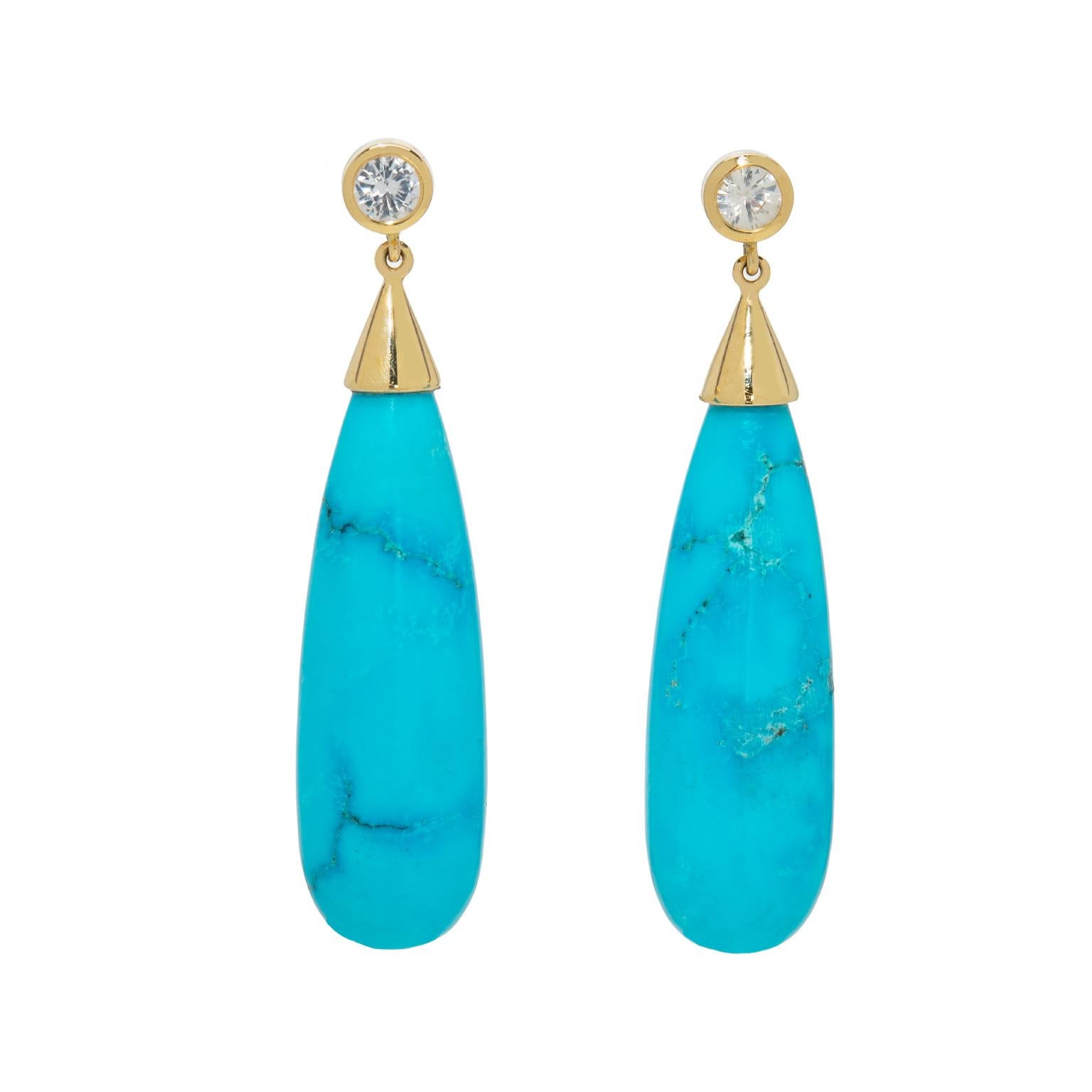 The stunning and vibrant blue of these drop turquoise stones will take your breath away. Nestled in 18k yellow gold, these magnificent earrings are topped only by the white round sapphires that sit directly on the ear lobe for a full sparkling