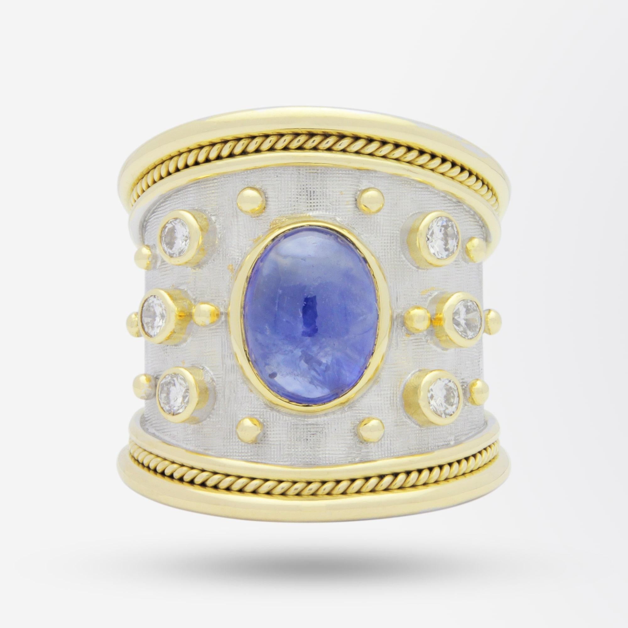 A fine gold, diamond and sapphire 'Templar' ring by esteemed British jeweller, Elizabeth Gage. The 18 karat yellow and white gold 'cigar' band shaped ring is set with a central 3.20 carat cabochon 'moderately bright mid slightly purplish blue