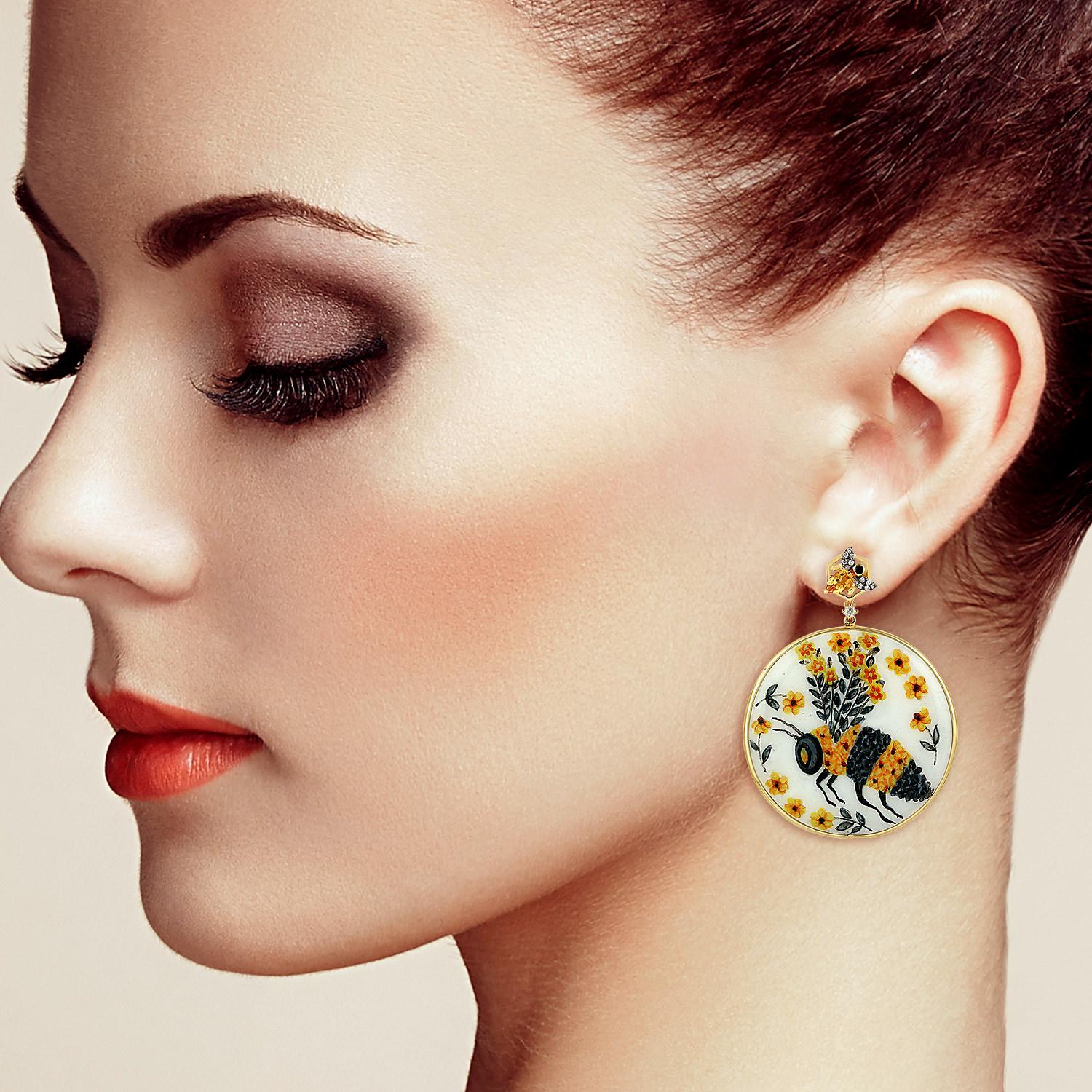 These beautiful enamel earrings features unique hand painted miniature art. Cast in 18K gold. It is set with .86 carats citrine, 78.11 carats bakelite & .35 carats pave diamonds. 

The ring is a size 7 and may be resized to larger or smaller upon