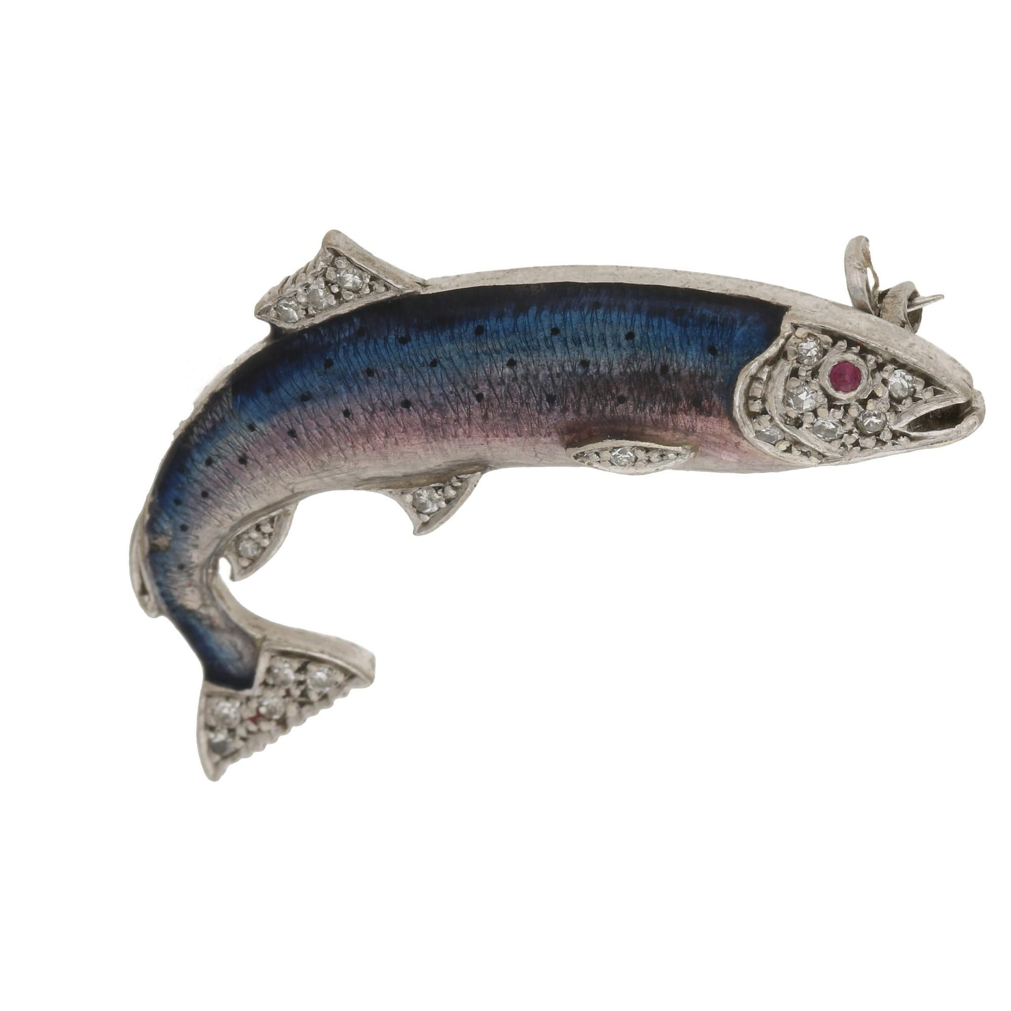 A detailed 1960's enamel and diamond 18ct white gold salmon brooch. With a neatly detailed guilloche enamel body, embellished with the fins and tail being detailed with eight cut diamonds, the face is adorned with diamonds and a round faceted ruby