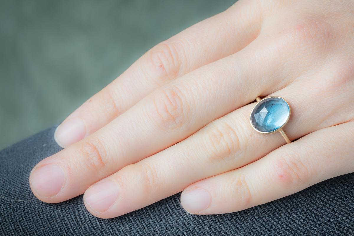 A lovely domed and faceted blue topaz ring set in 18K gold.  Carat weight of blue topaz is 7.81.  Ring size is 6.75.