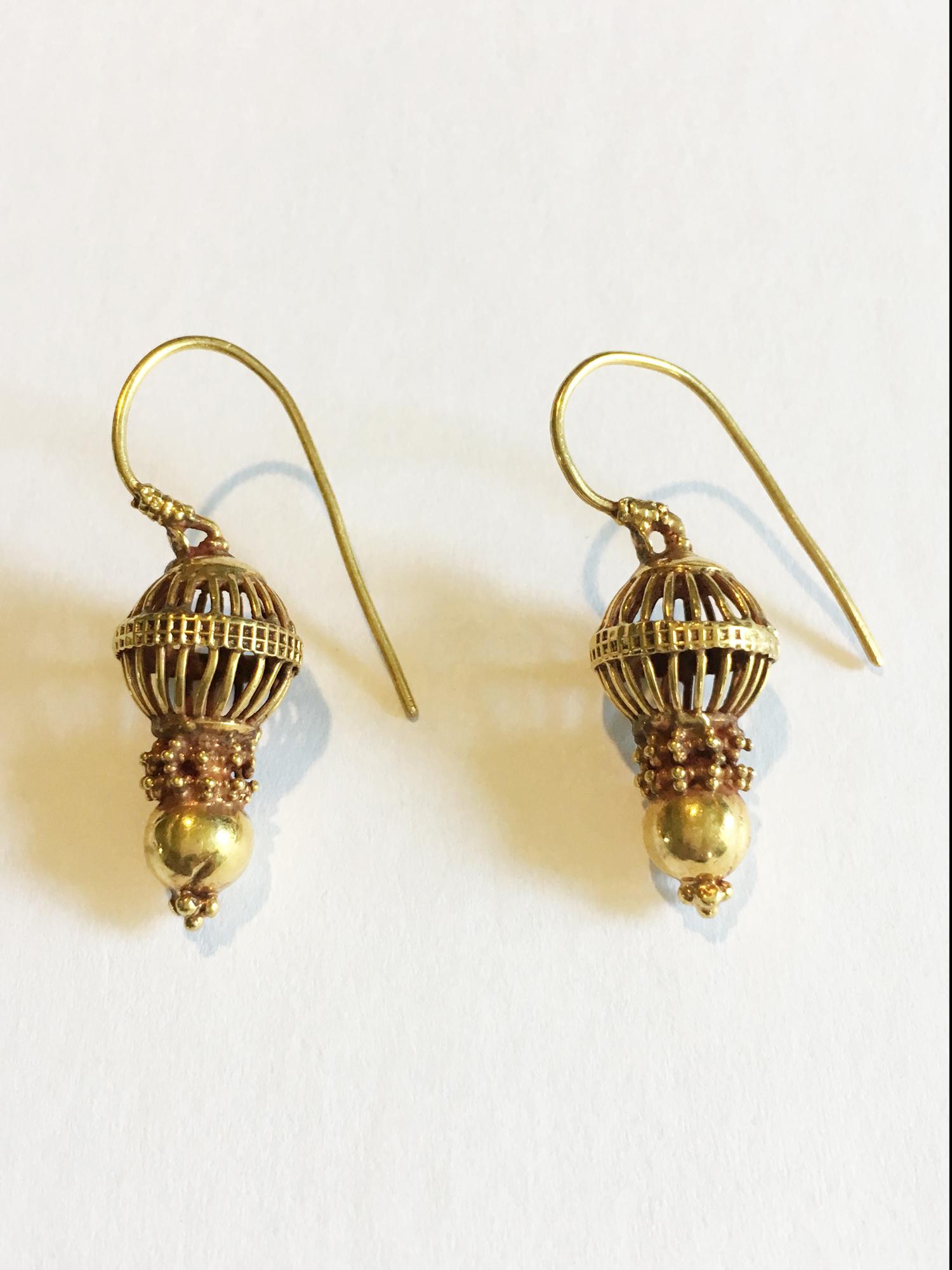 A wonderful pair of traditional 18 karat gold earrings with granulation work from central India. Made by hand in the mid-20th century, these delicately crafted earrings are versatile and easy-to-wear. Each earring weighs 3.3 grams.