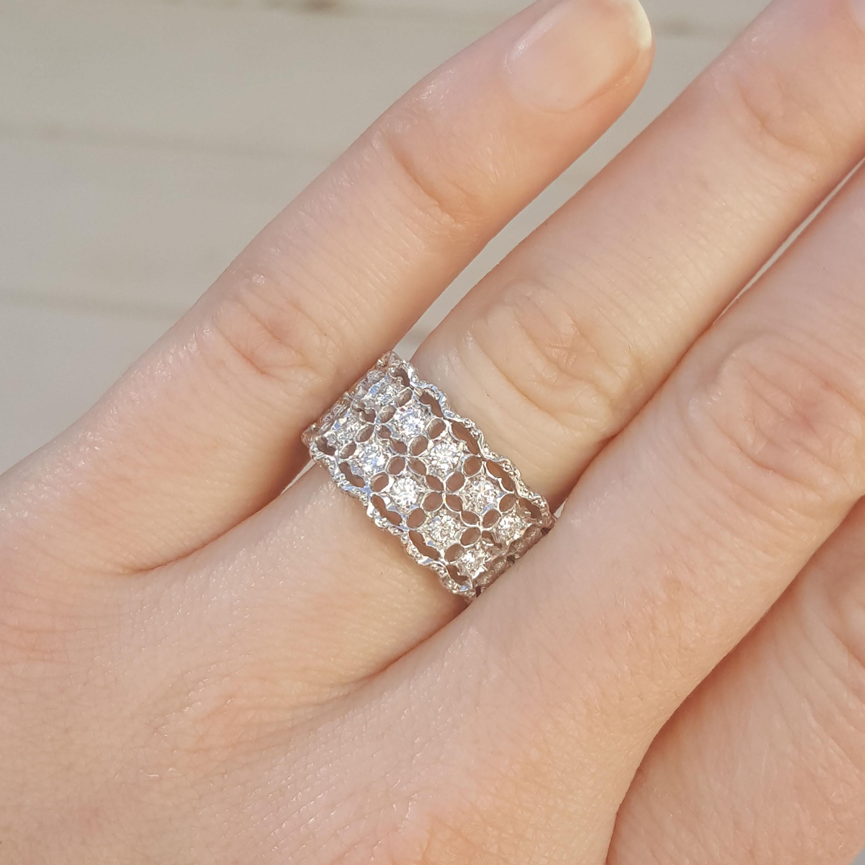 The Stefania collection is all grace and delicacy, and this wide band is an excellent example. Two rows of beautiful diamonds are held in an all white scalloped setting, entirely hand-fabricated and hand-engraved.

This wide diamond band has great