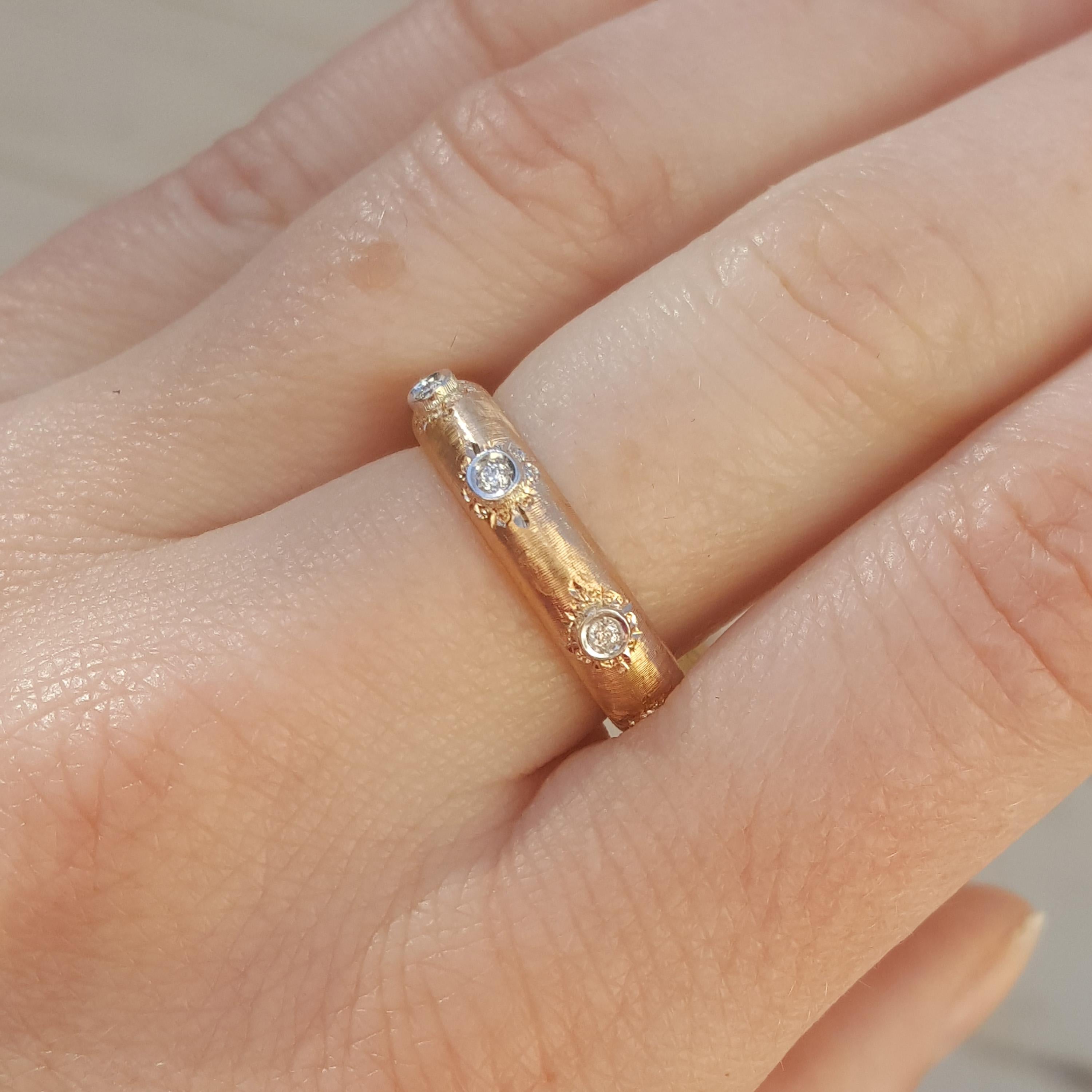 Adriana is an utterly modern ring, with old world sensibilities. The diamonds in clean bezel settings stand out against the delicately engraved surface of the band.

This is an eternity style of diamond band, and it's a great size either on its own