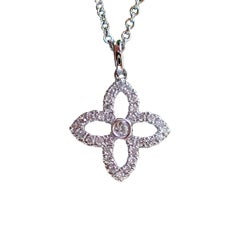 18 Karat Gold Flower Pendant with 0.19 Carat of Diamond Hangs from a Cable Chain