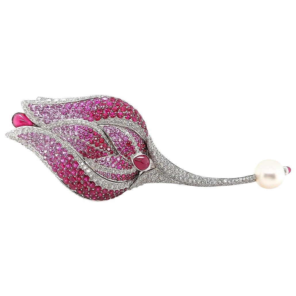 Magnificent Fred 18Kt White Gold Tulip/Rose Brooch, Pendant With Diamonds,Ruby,Sapphires & South Sea Pearl

Comes with a double necklace chain with 6 yellow diamonds and 6 rubies which was later added as it finished off this piece of jewellery so