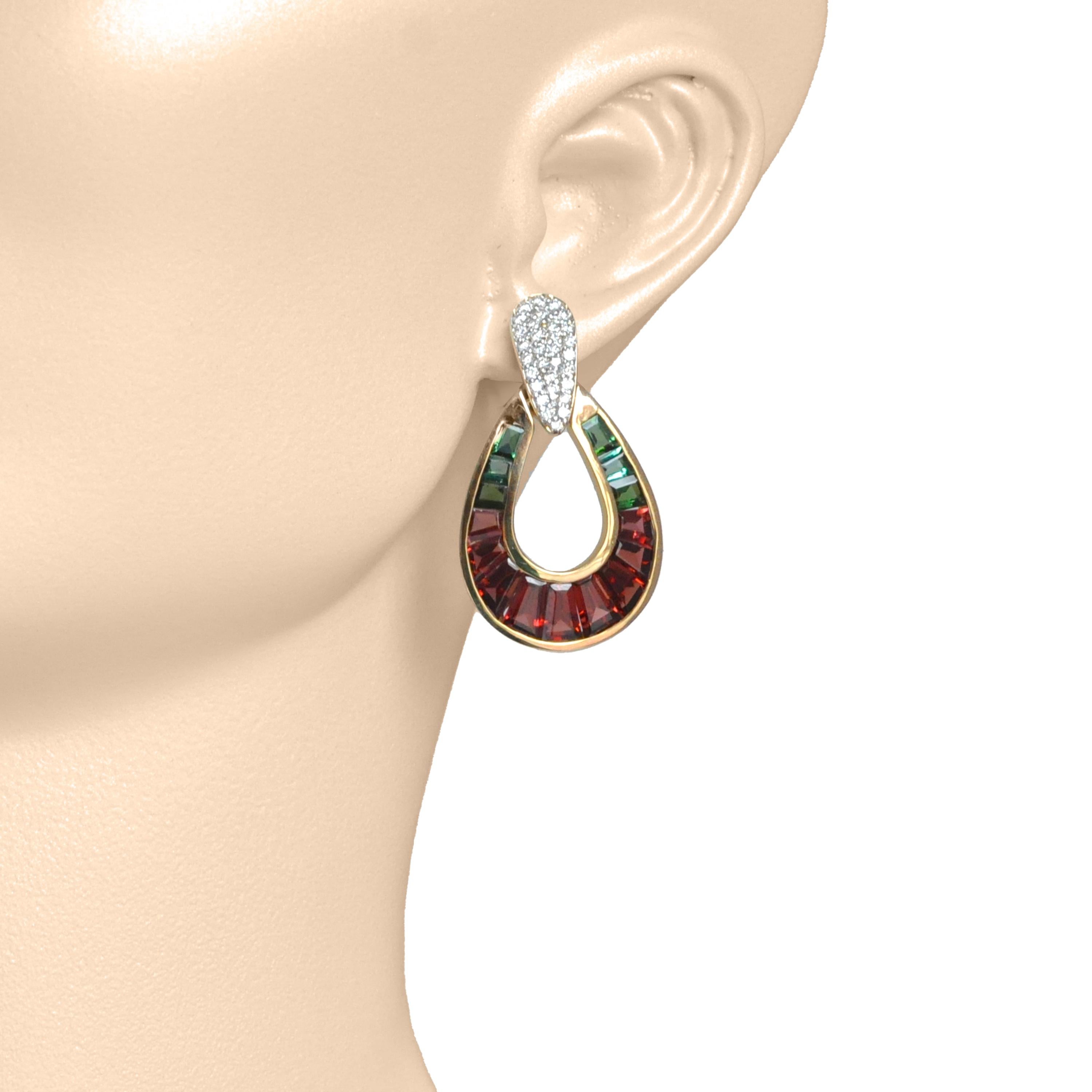 18k gold garnet green tourmaline diamond door-knocker earrings.

Introducing our 18k gold garnet green tourmaline diamond raindrop earrings—a fusion of elegance and brilliance, designed to captivate.

Handcrafted with precision and using the finest