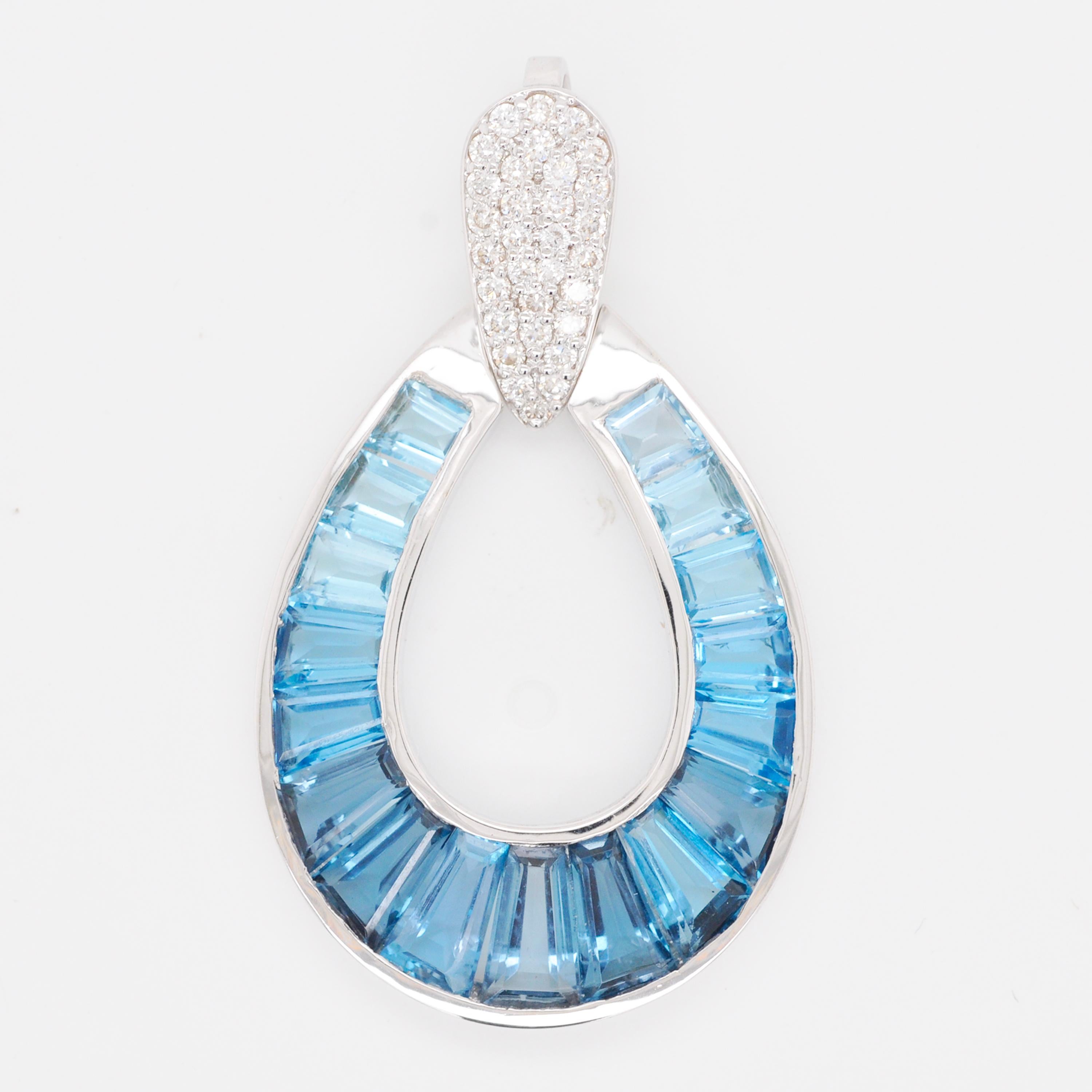 18 karat gold gradient blue topaz taper baguette raindrop diamond pendant necklace.

Absolutely stunning, this blue topaz pendant is set in 18 karat gold using best international alloys. The perfectly crafted tear drop or as some people call it